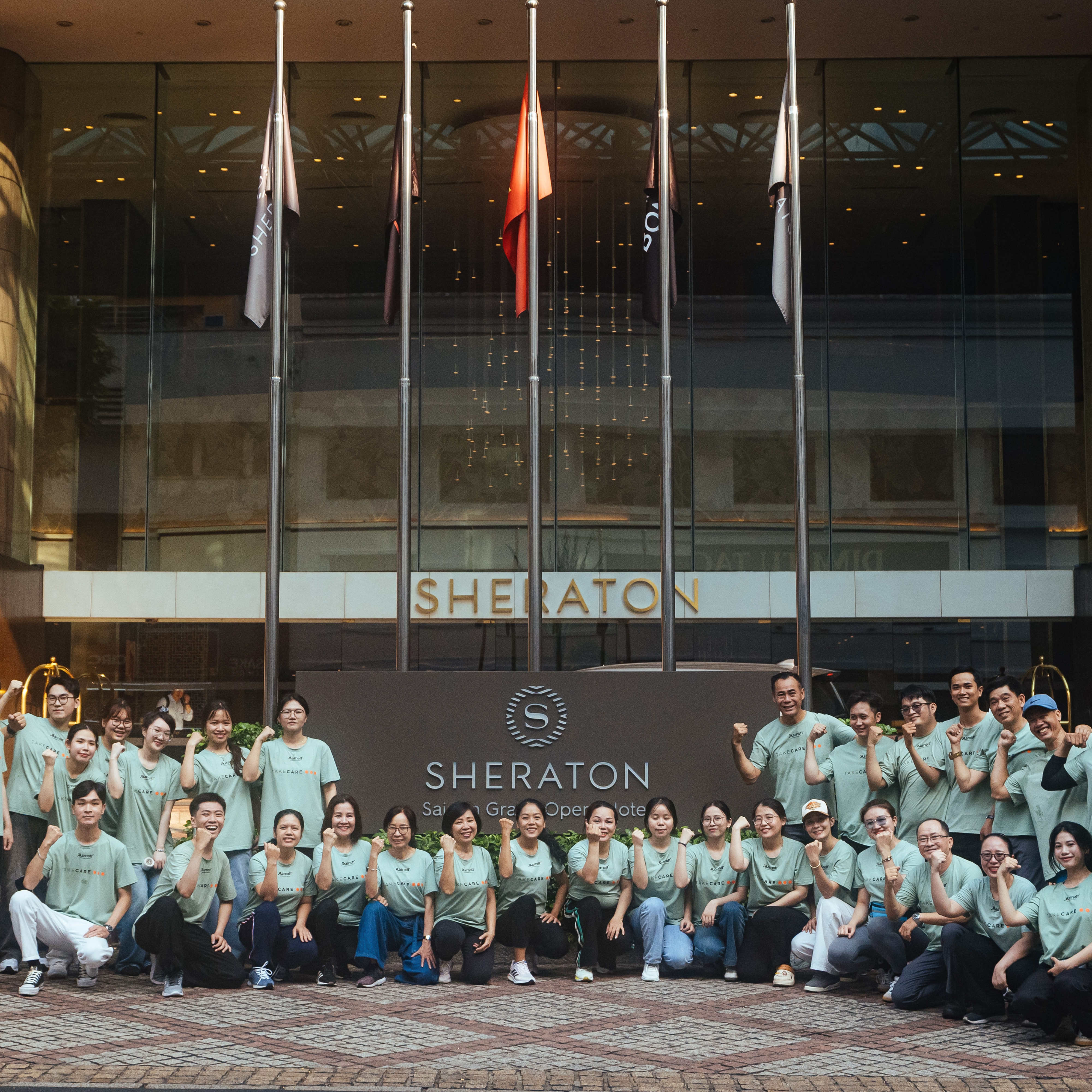 Associates group photo outside Sheraton Saigon Grand Opera Hotel