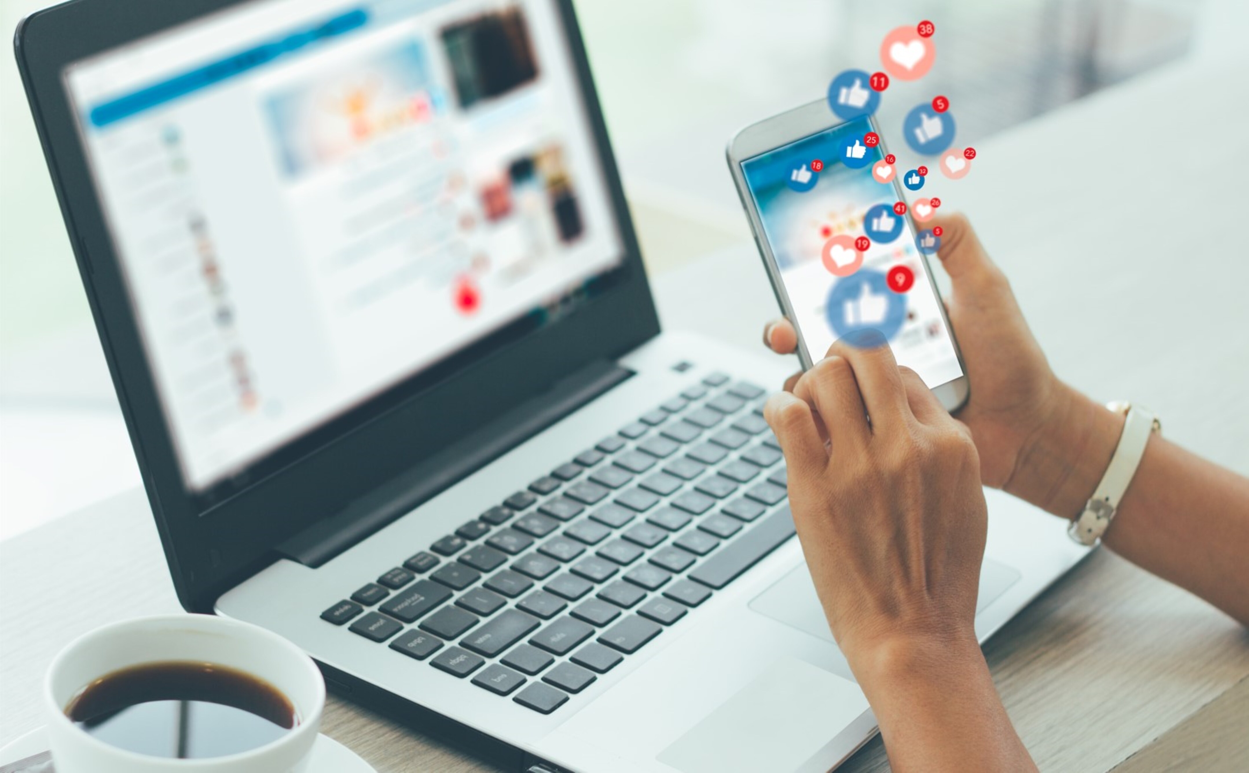 Laptop open while holding phone