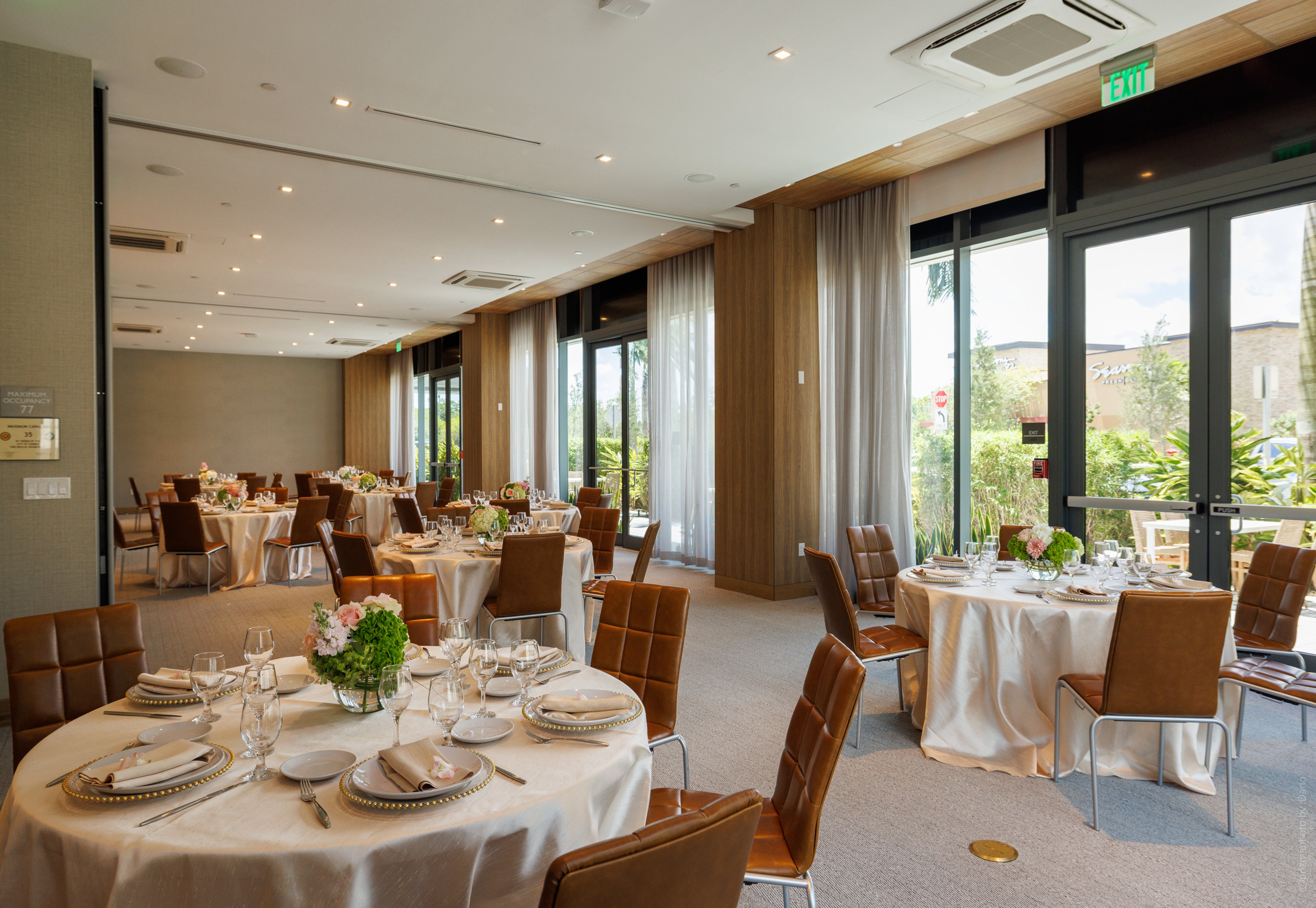 Wedding reception in ballroom with large windows