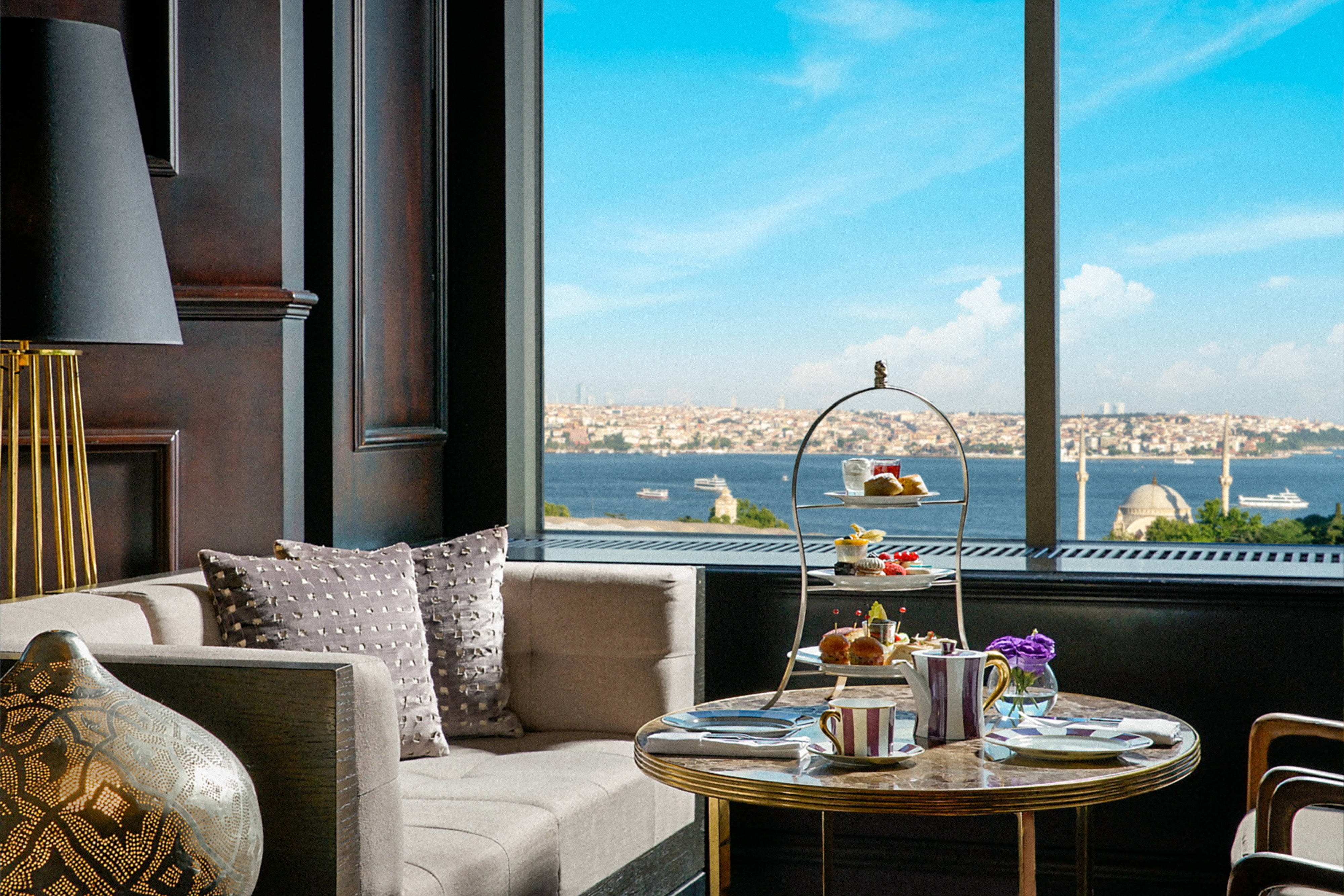 Stately interior with tea setup overlooking bay.