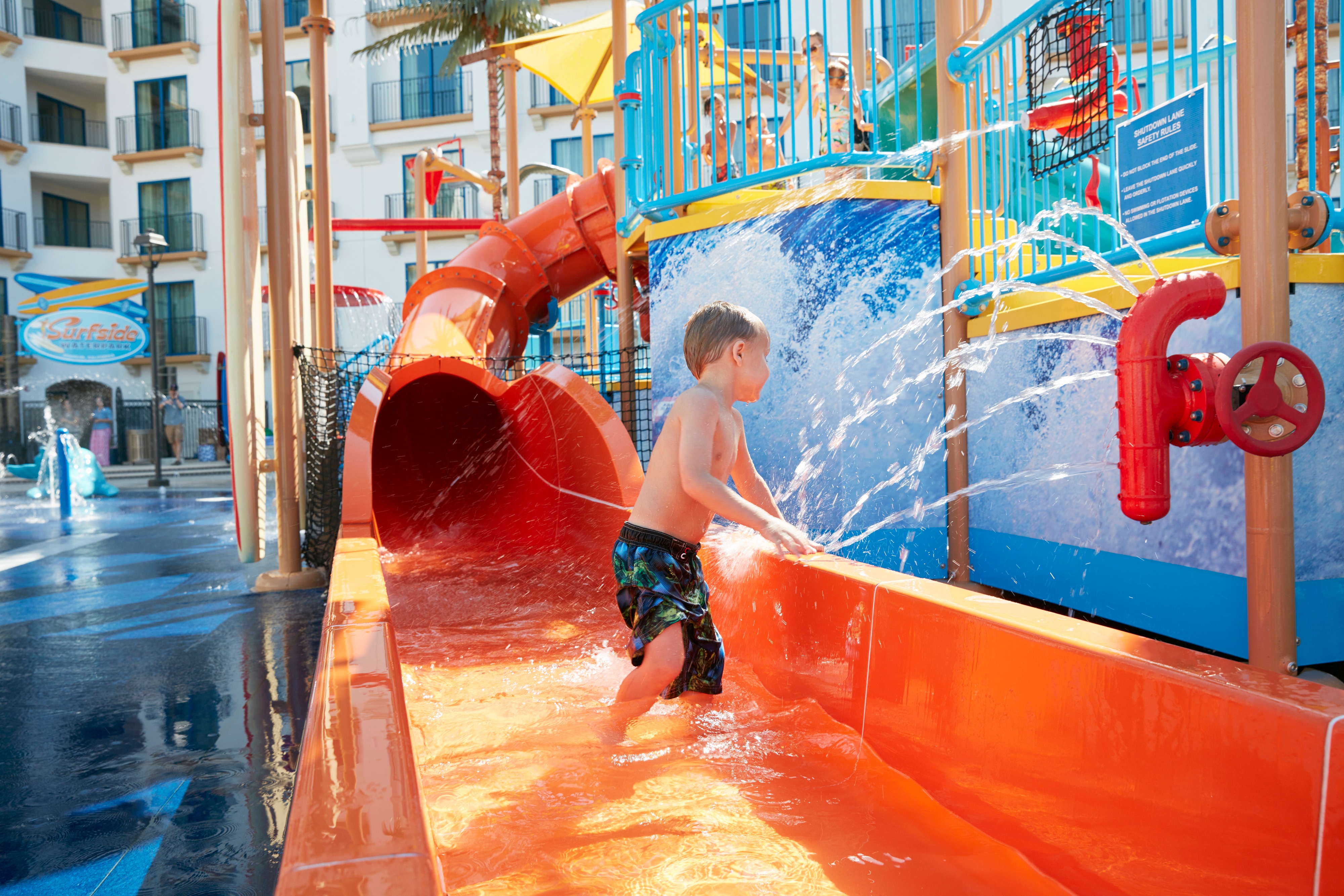 Child on water slide.