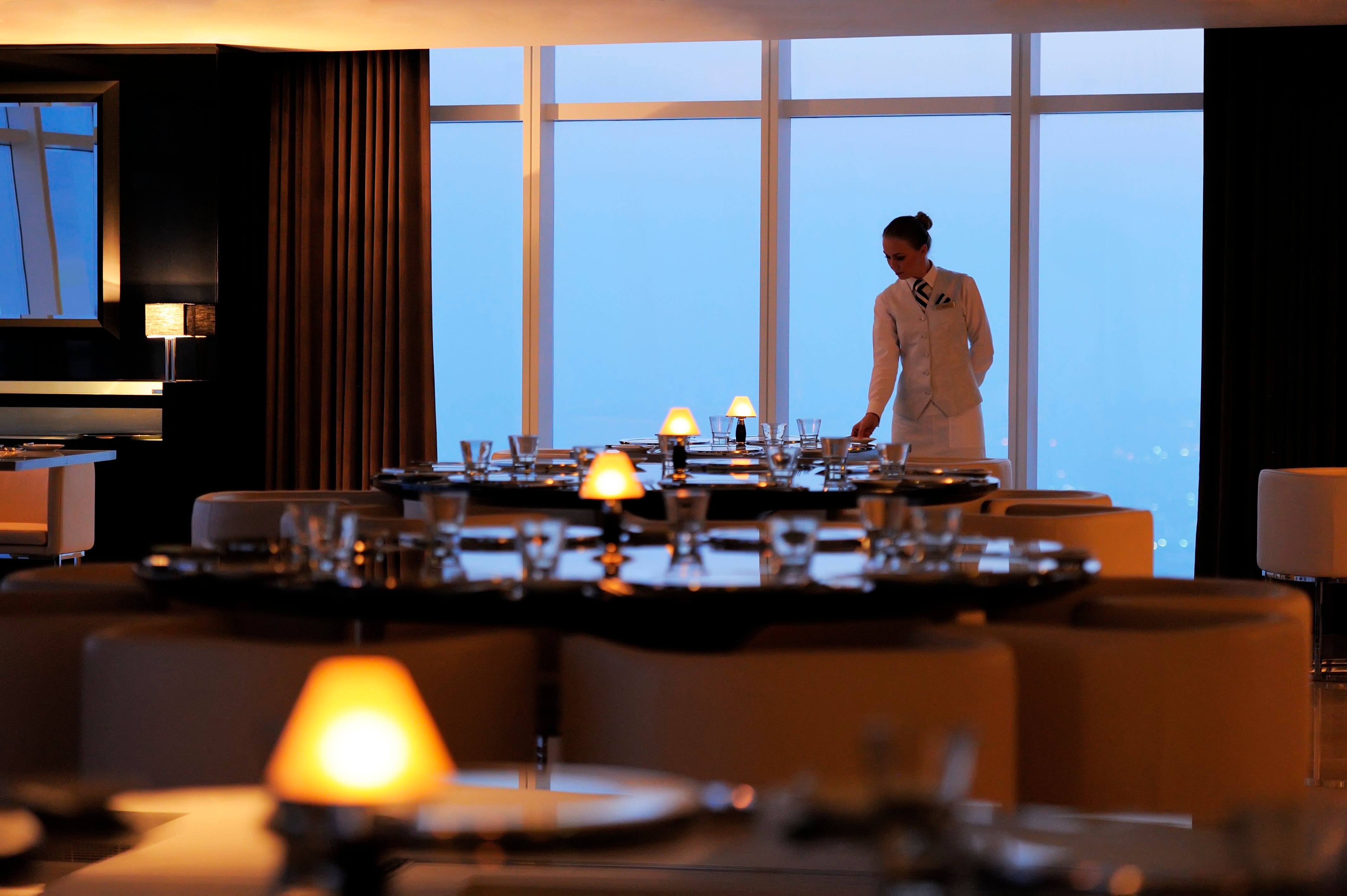 Restaurant staff setting a dining table