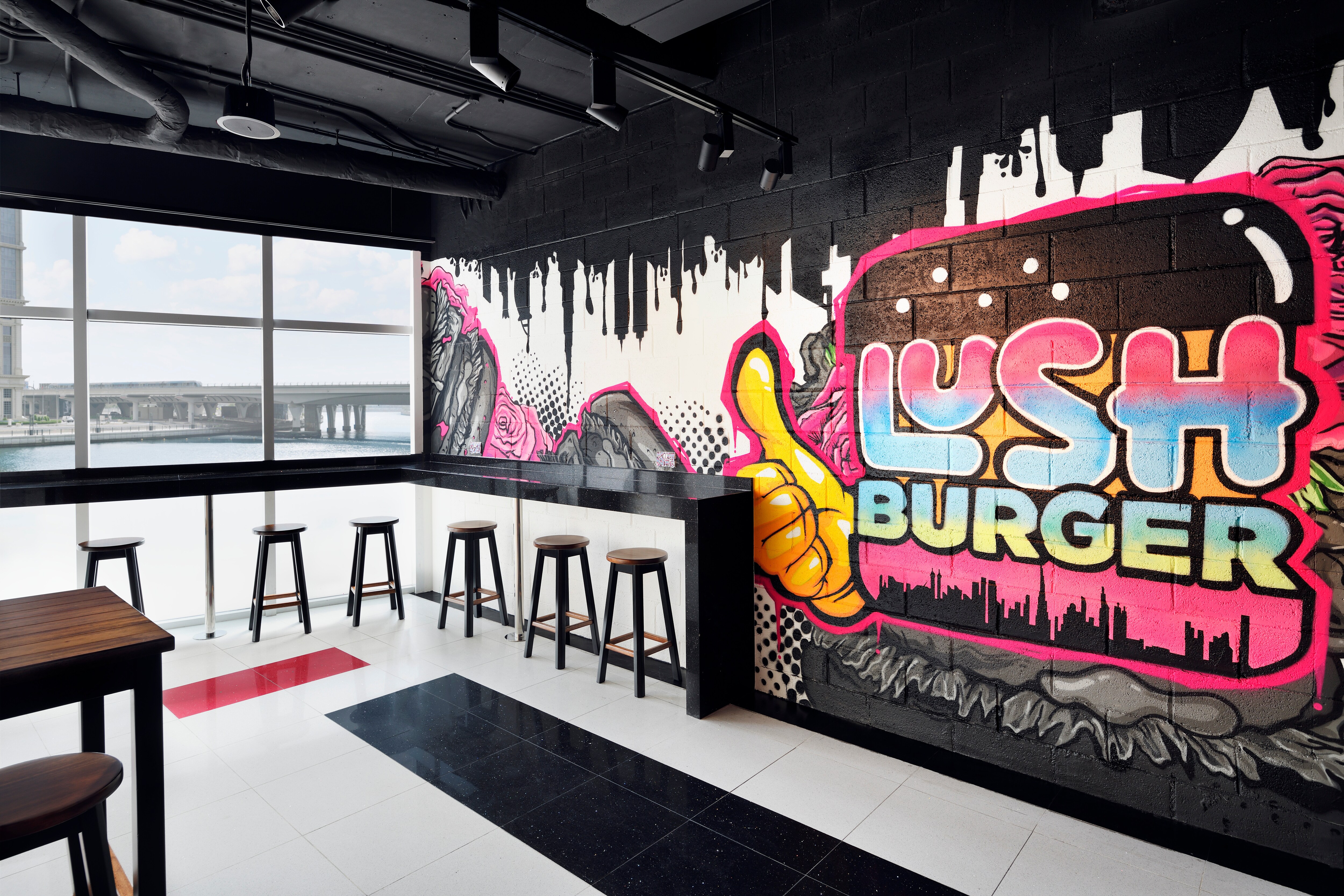 Restaurant dining room with lush burger wall mural