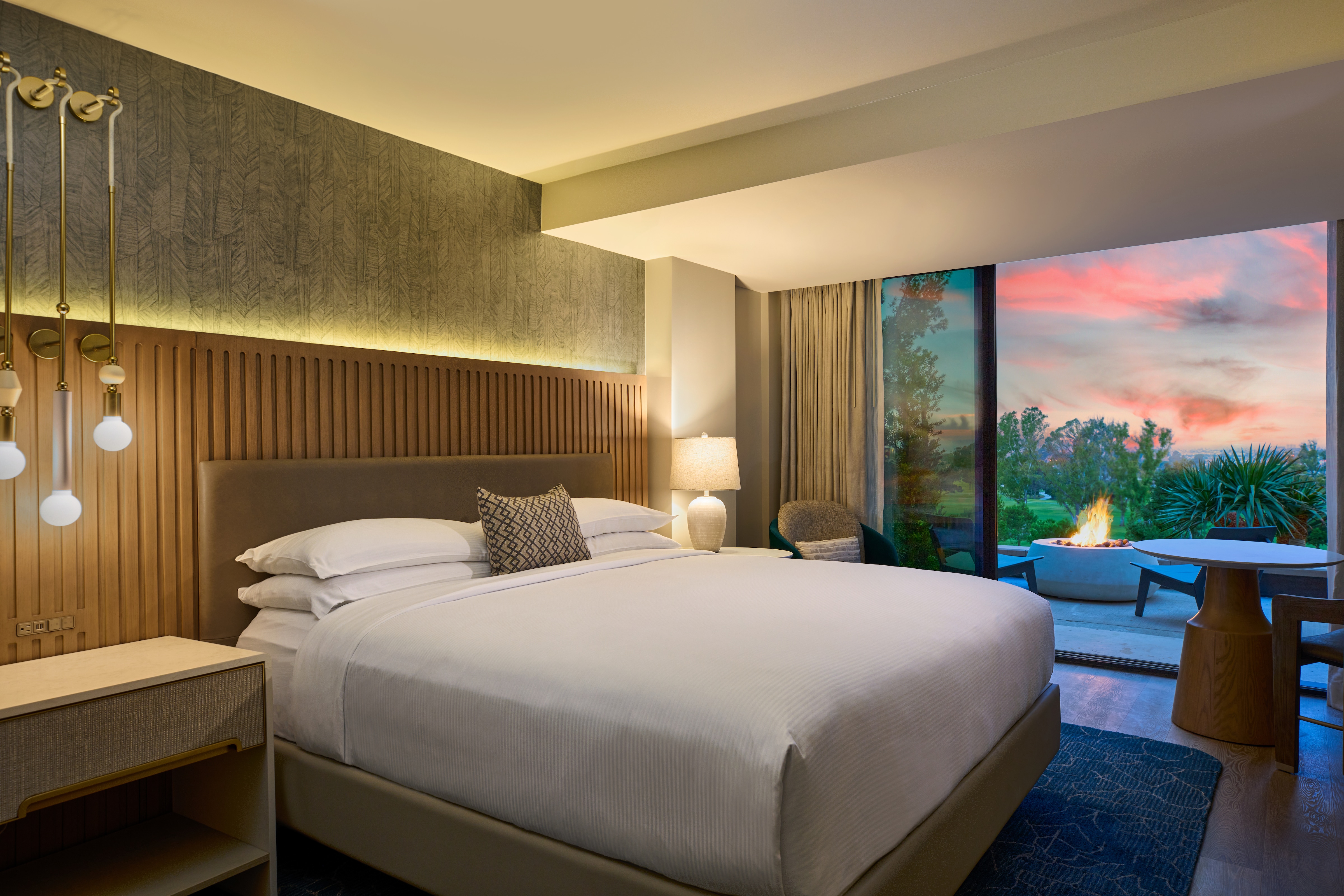 Guest suite bedroom with outdoor patio and firepit