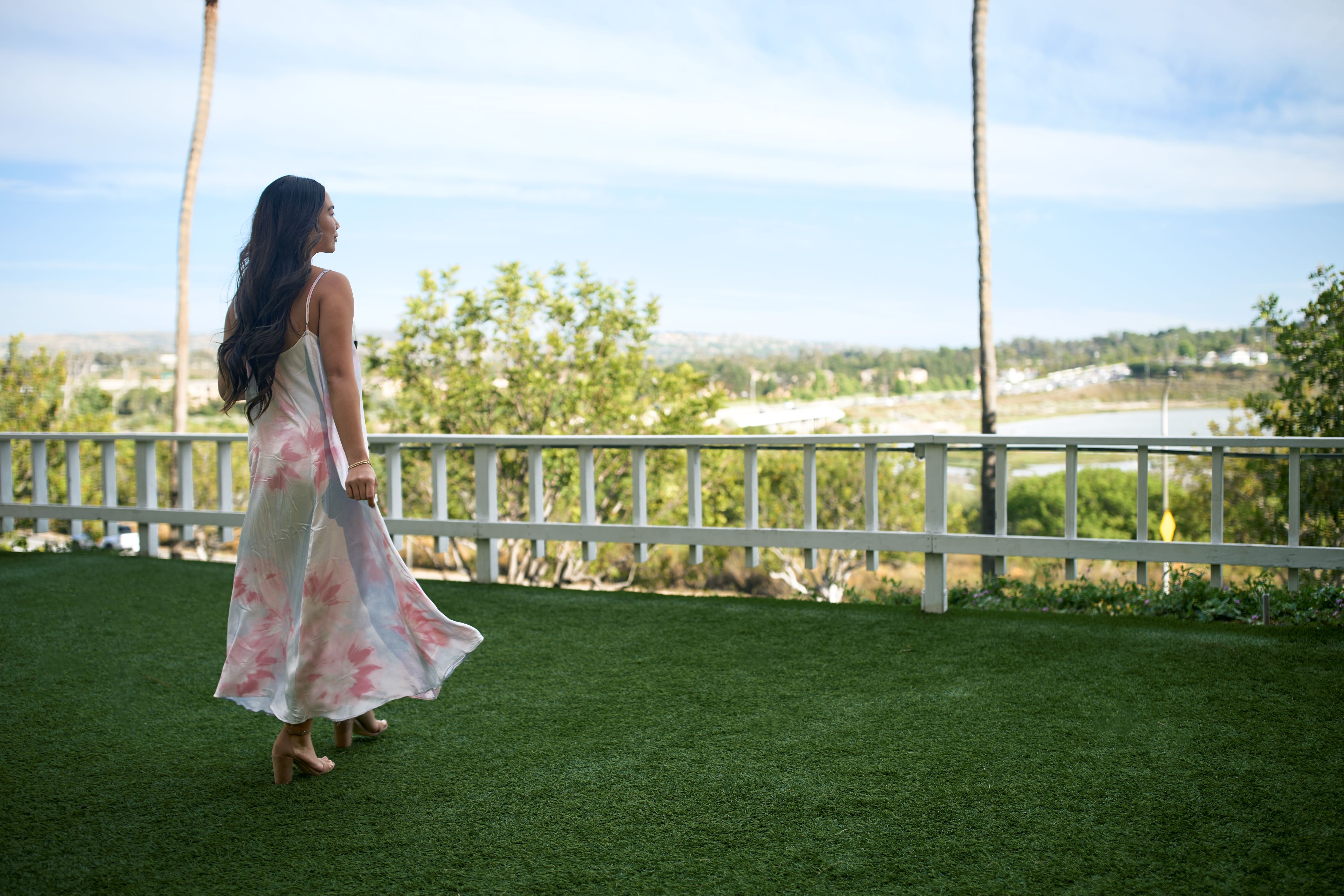 Woman walking on lawn enjoying the scenery.