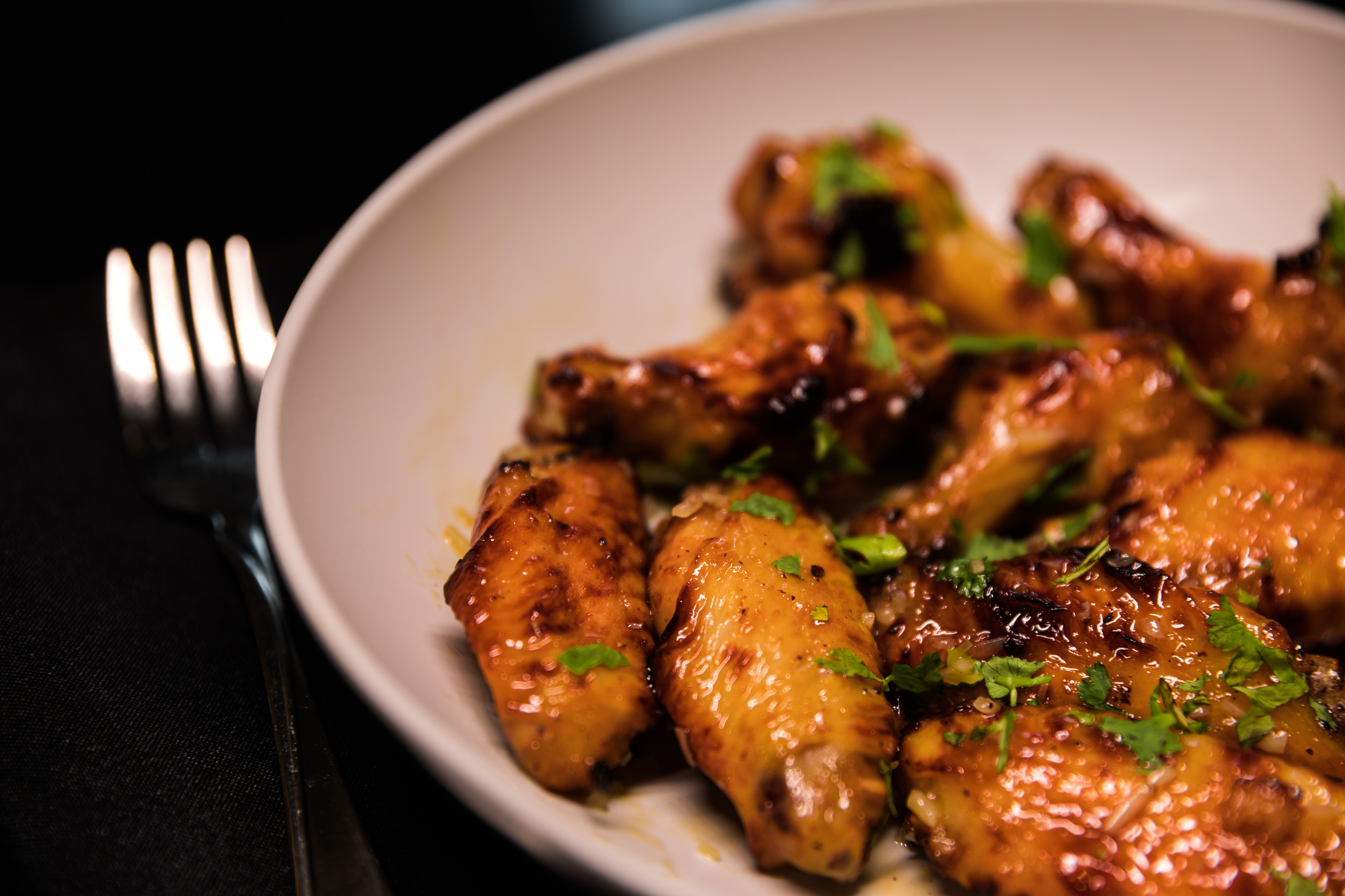 Plate of grilled chicken wings in signature sauce
