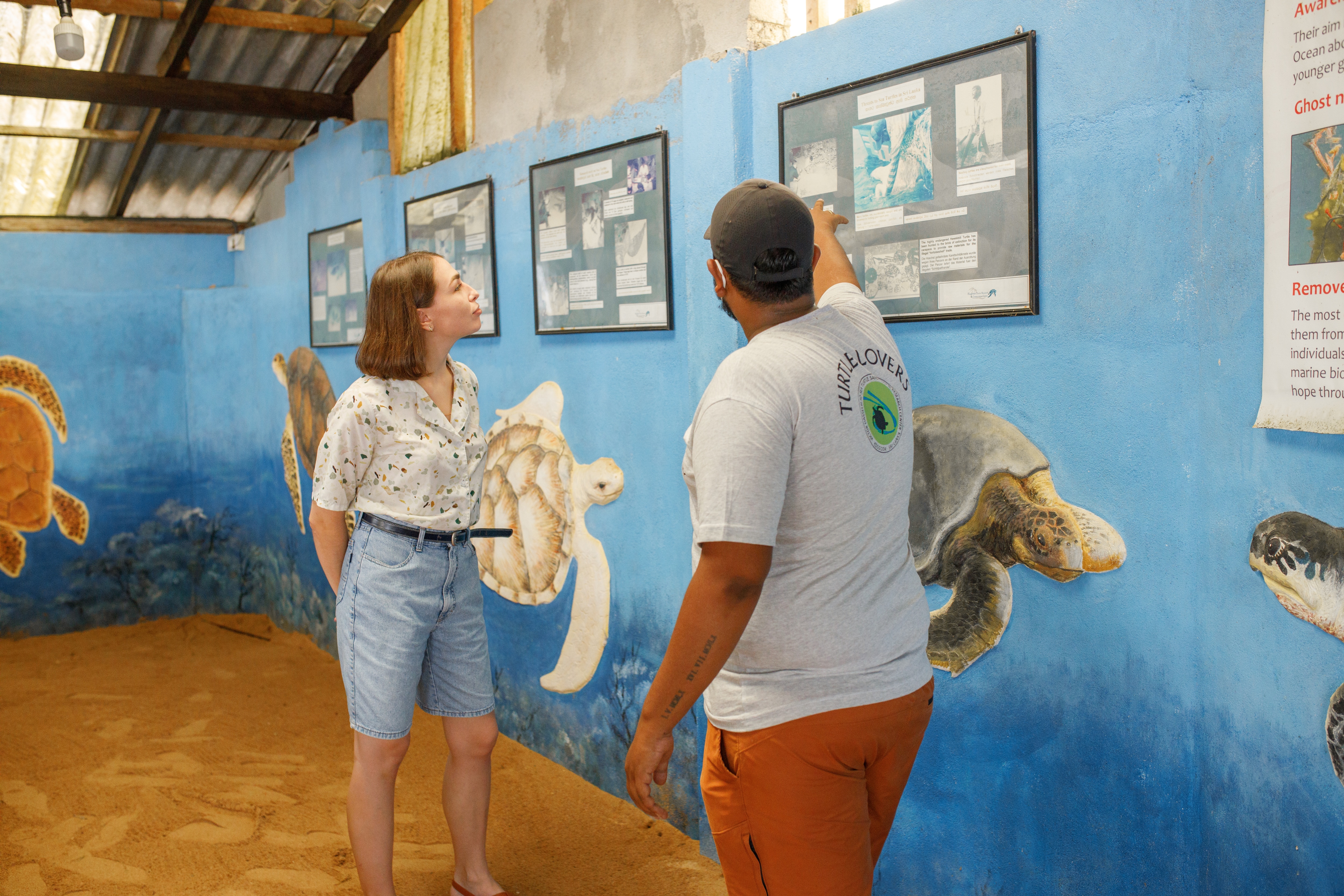 Women Standing At Sign Learning about Turtles
