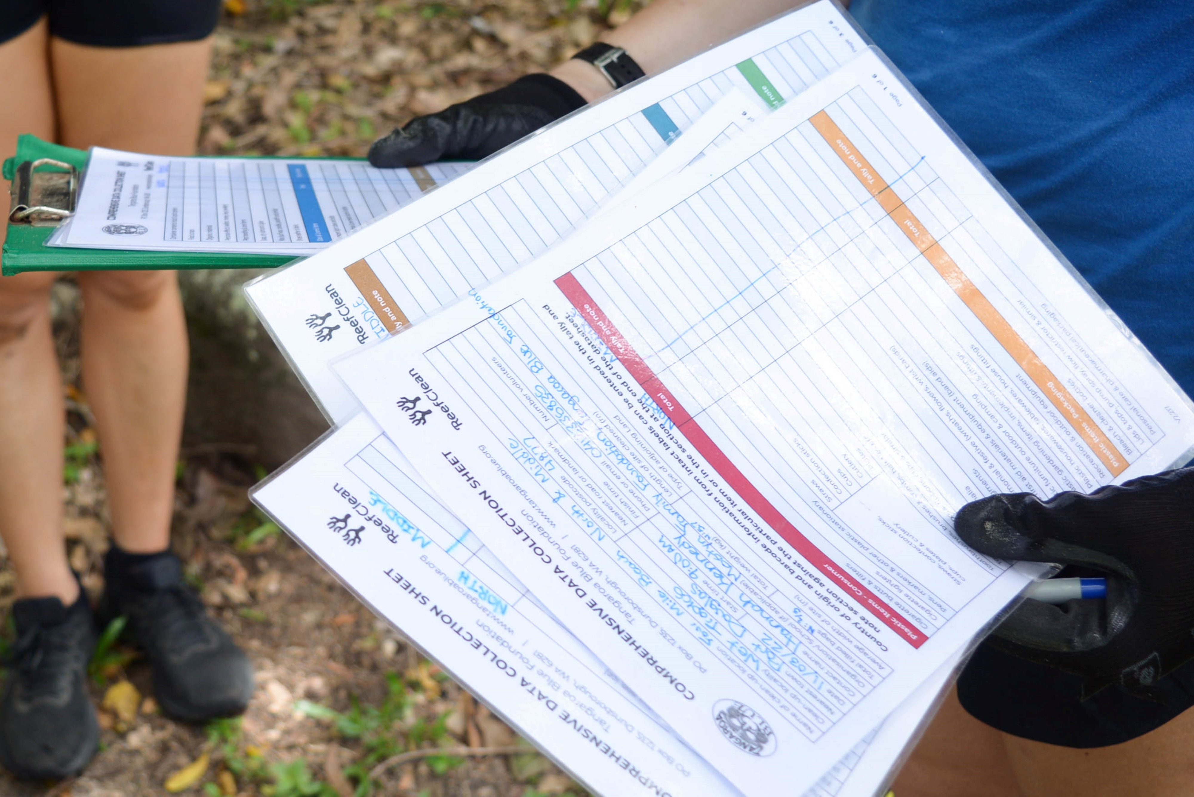 Person holding a data reporting sheet.