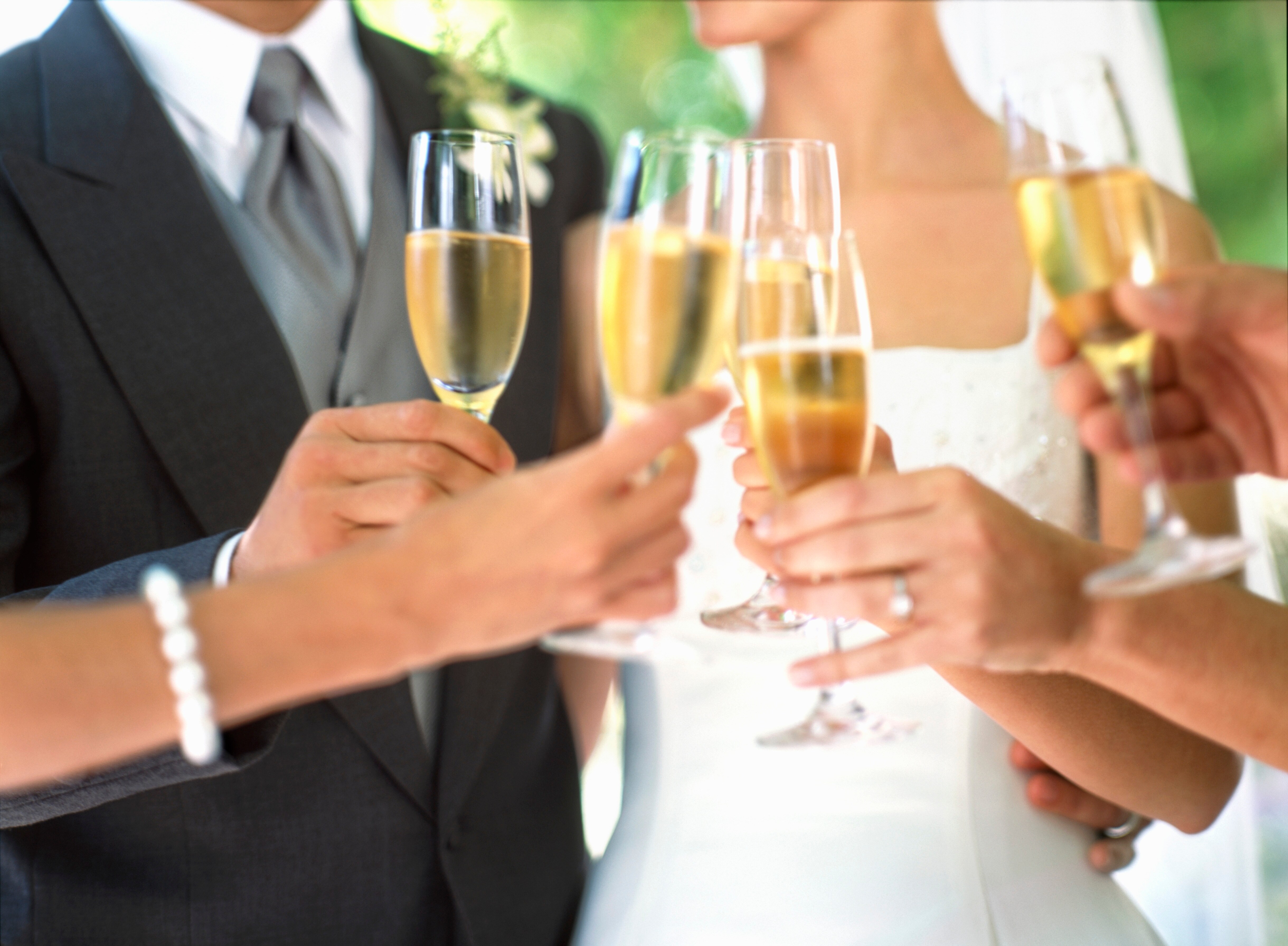 Bride and groom toasting champagne glasses