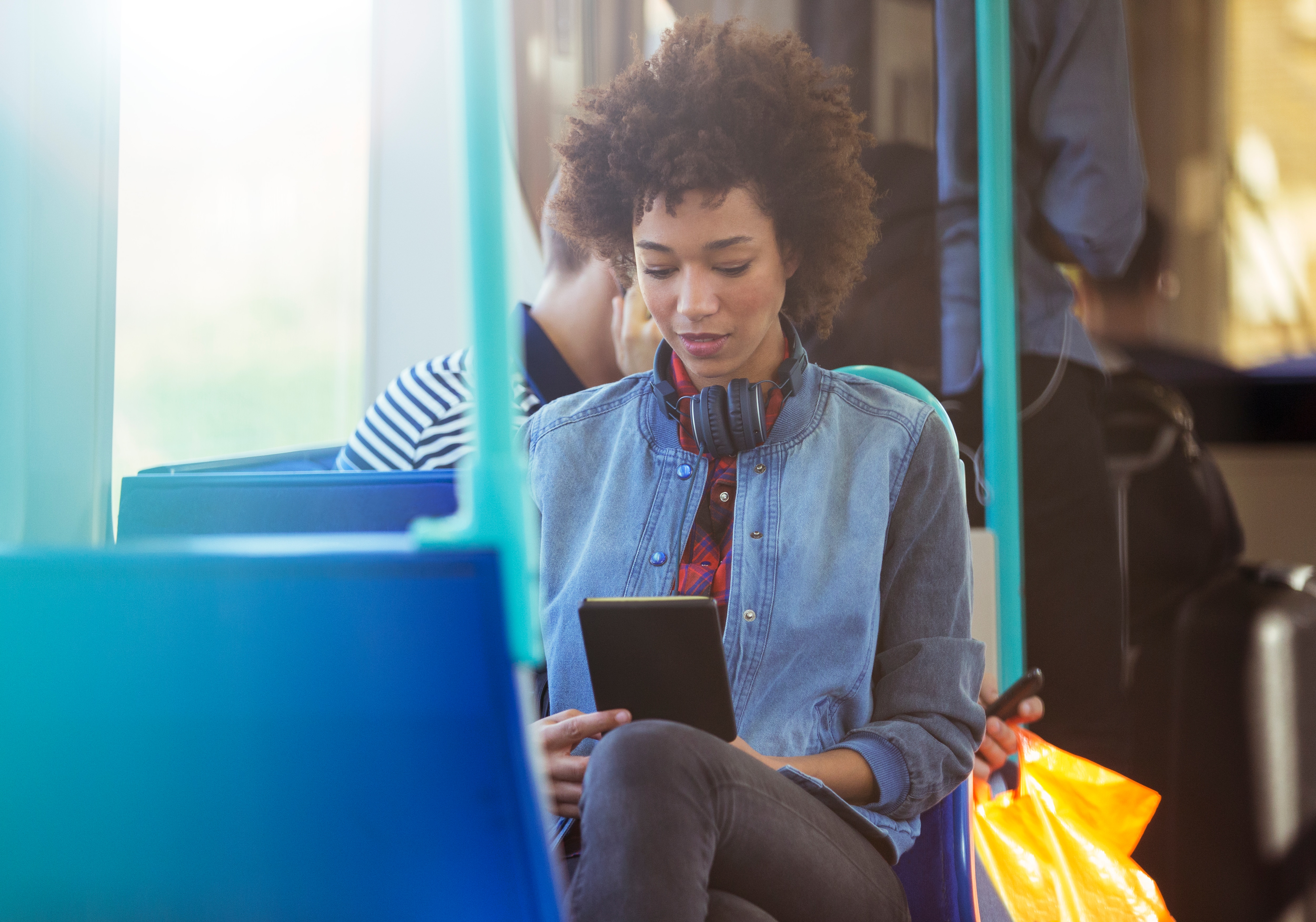 Woman using digital tablet on train