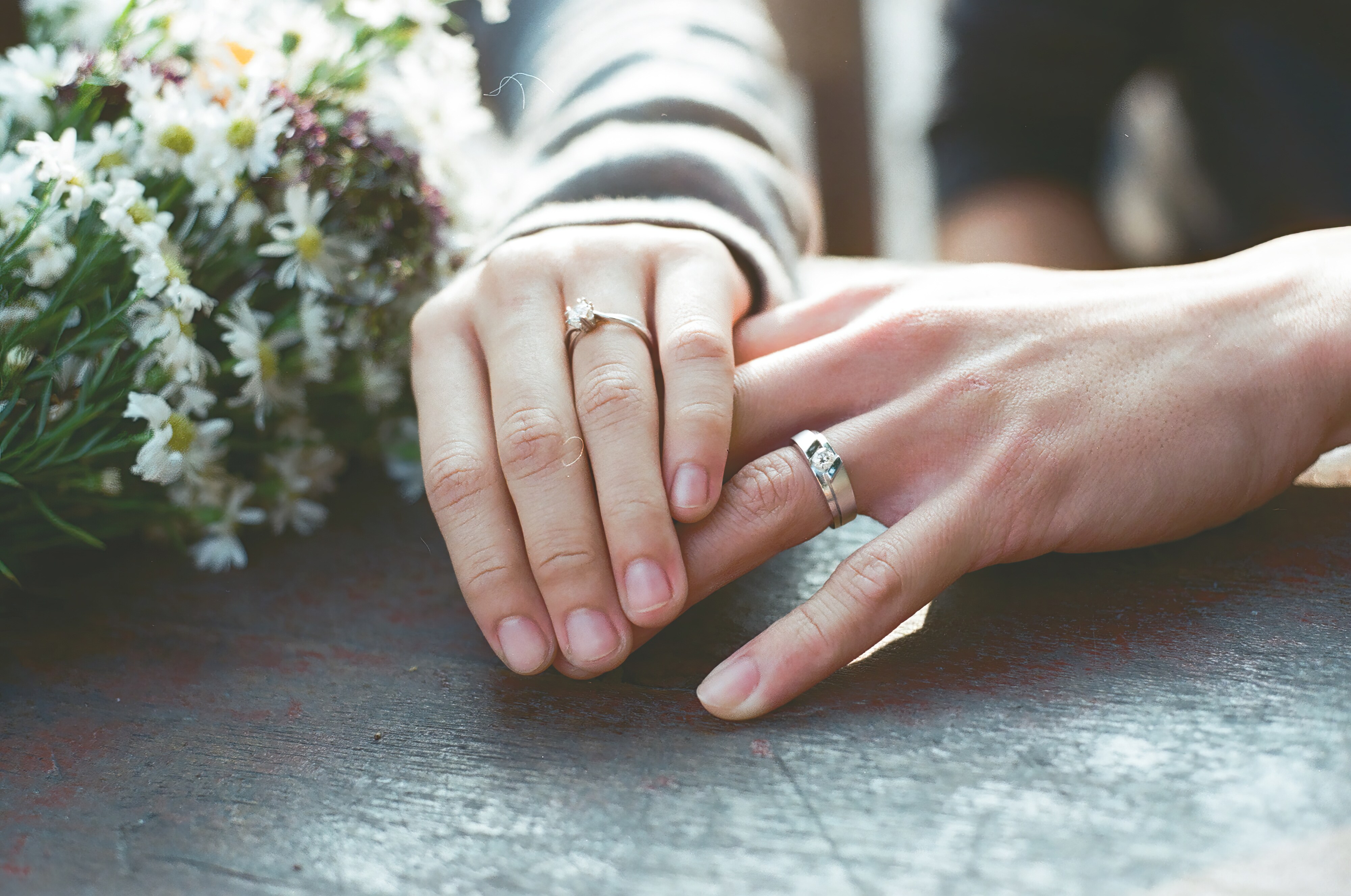 Hands with wedding bands touching