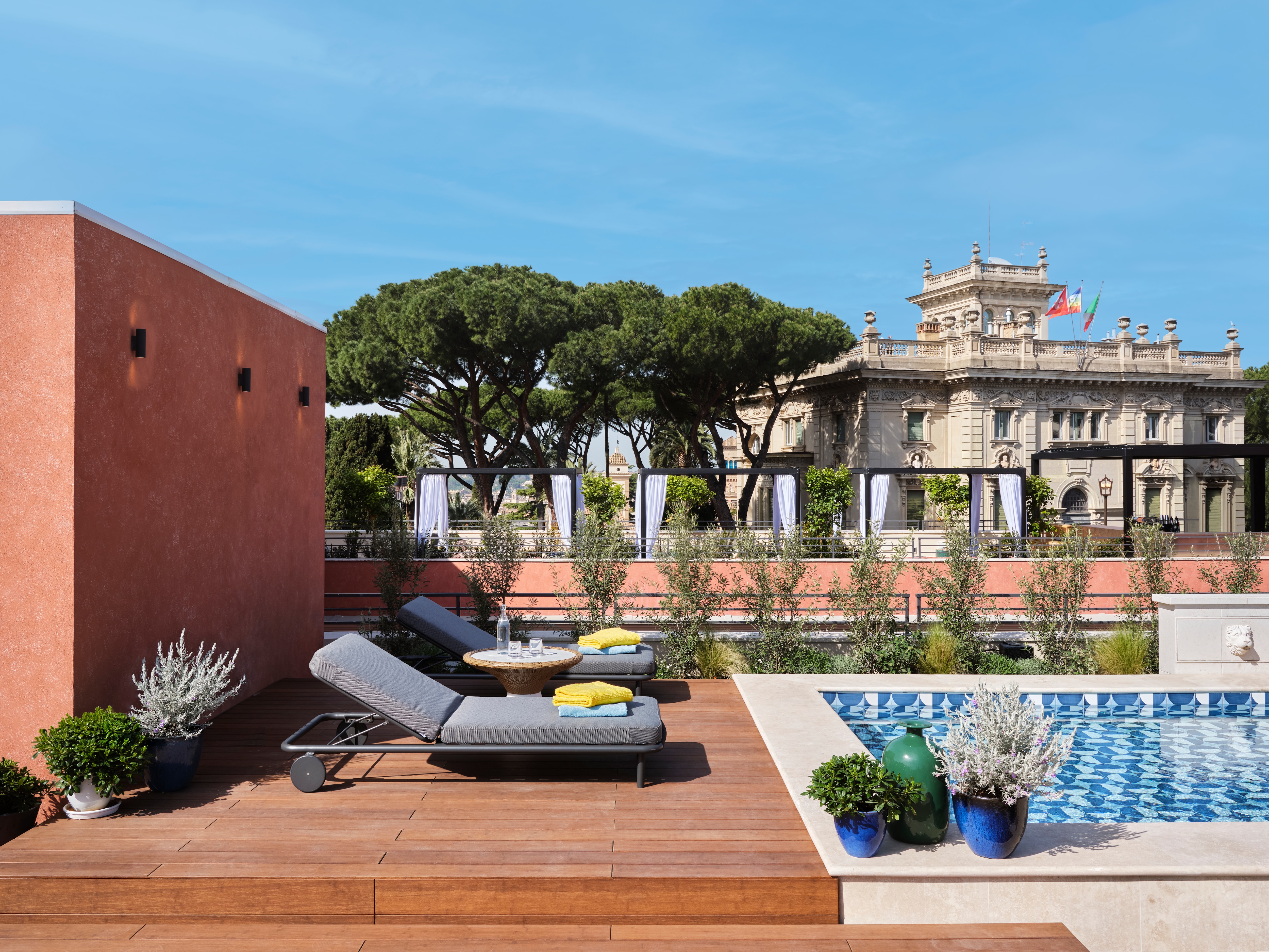 Lounge beds beside an outdoor swimming pool