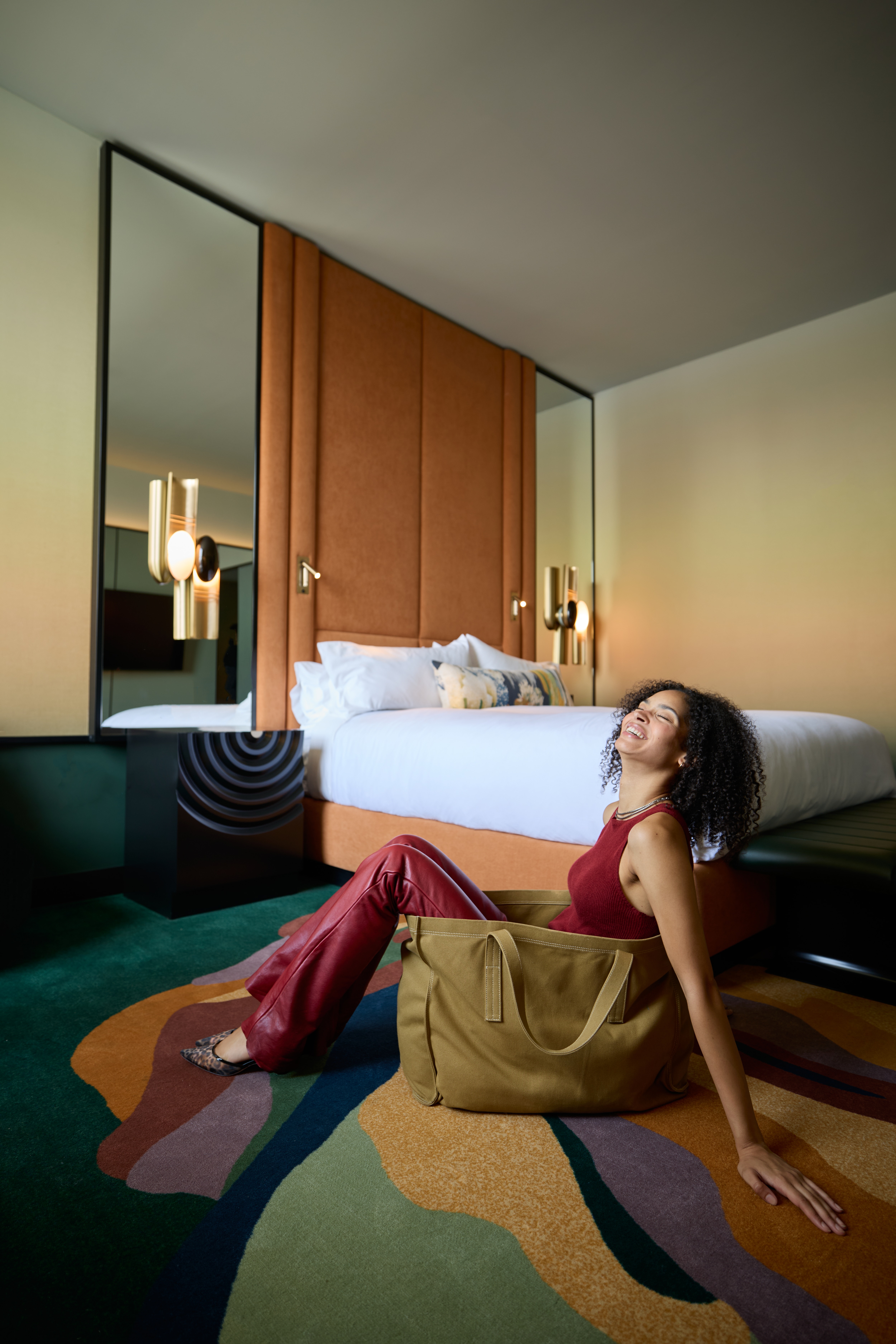 Woman sitting on the floor in her hotel room