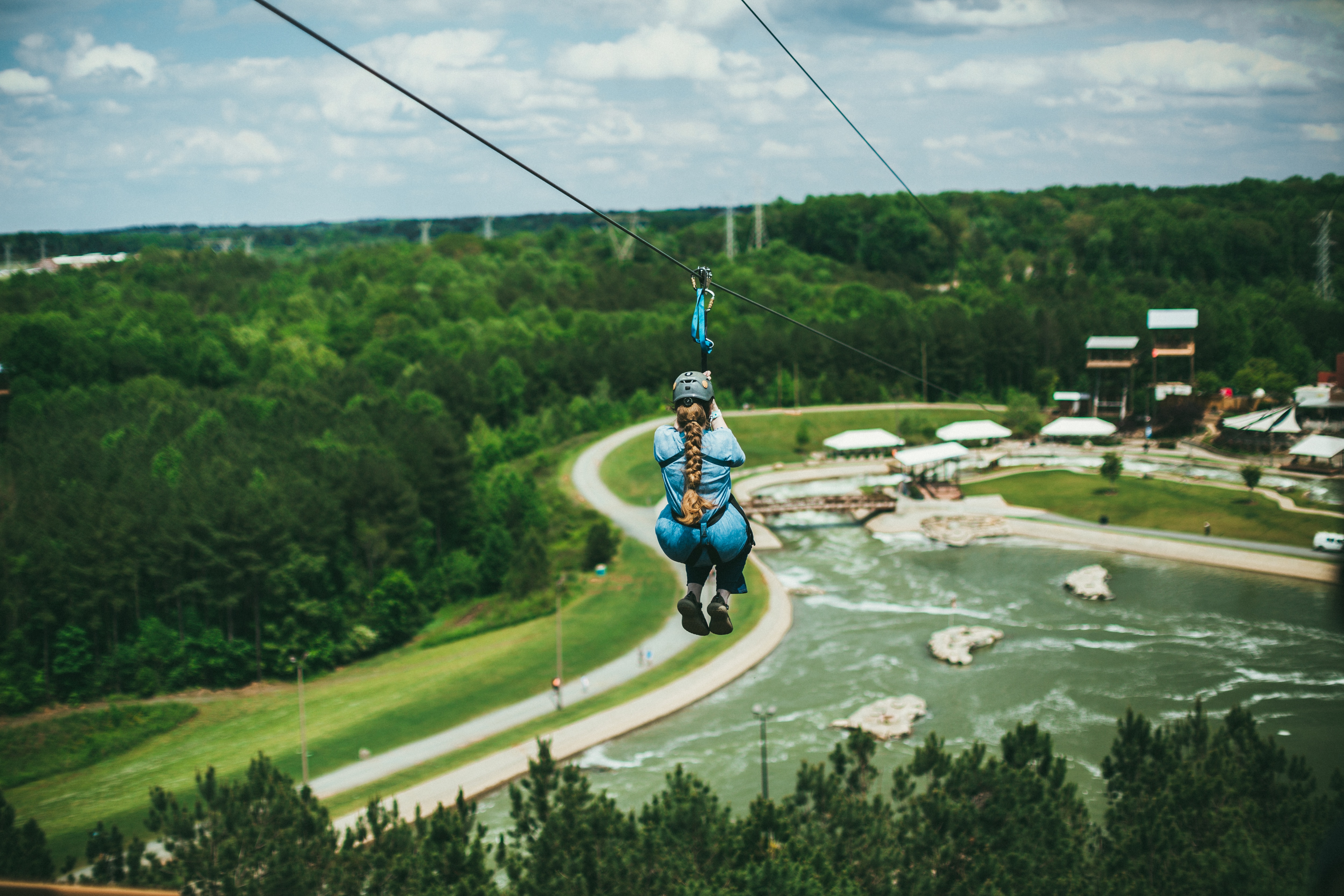 Person ziplining at a whitewater park