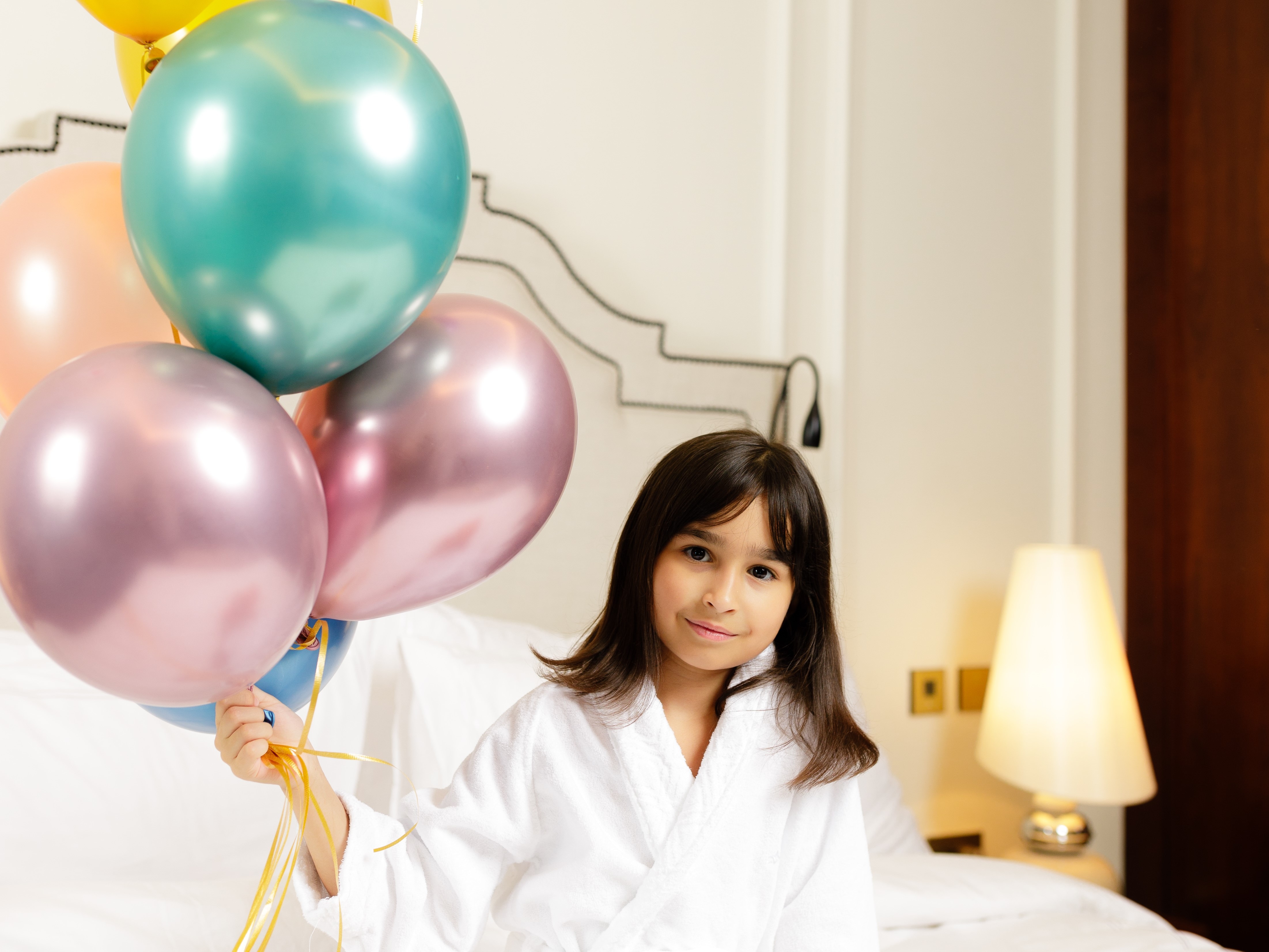 Child posing with balloons