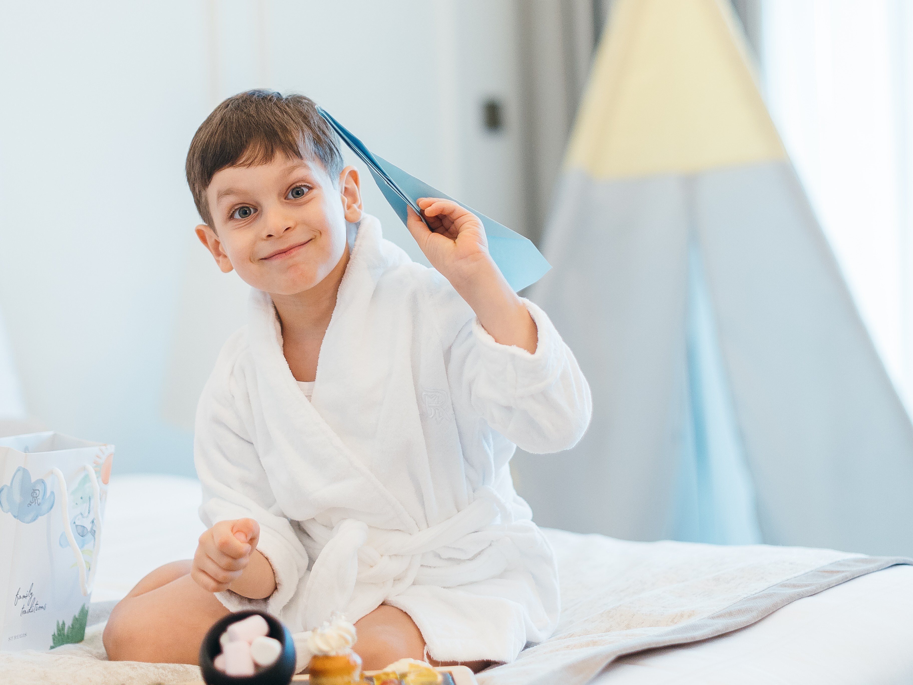 Child playing with a paper airplane
