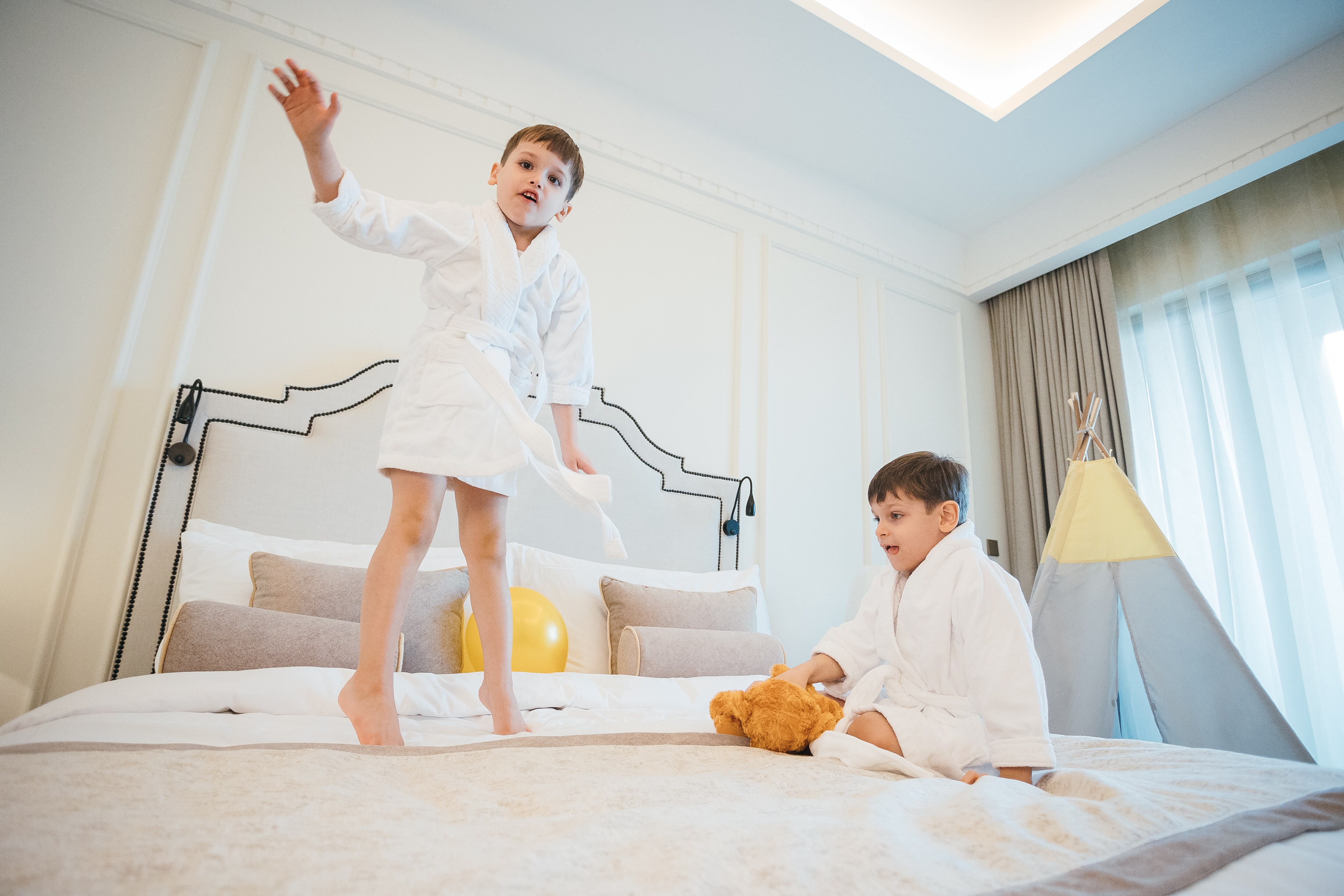 Kids jumping on a bed