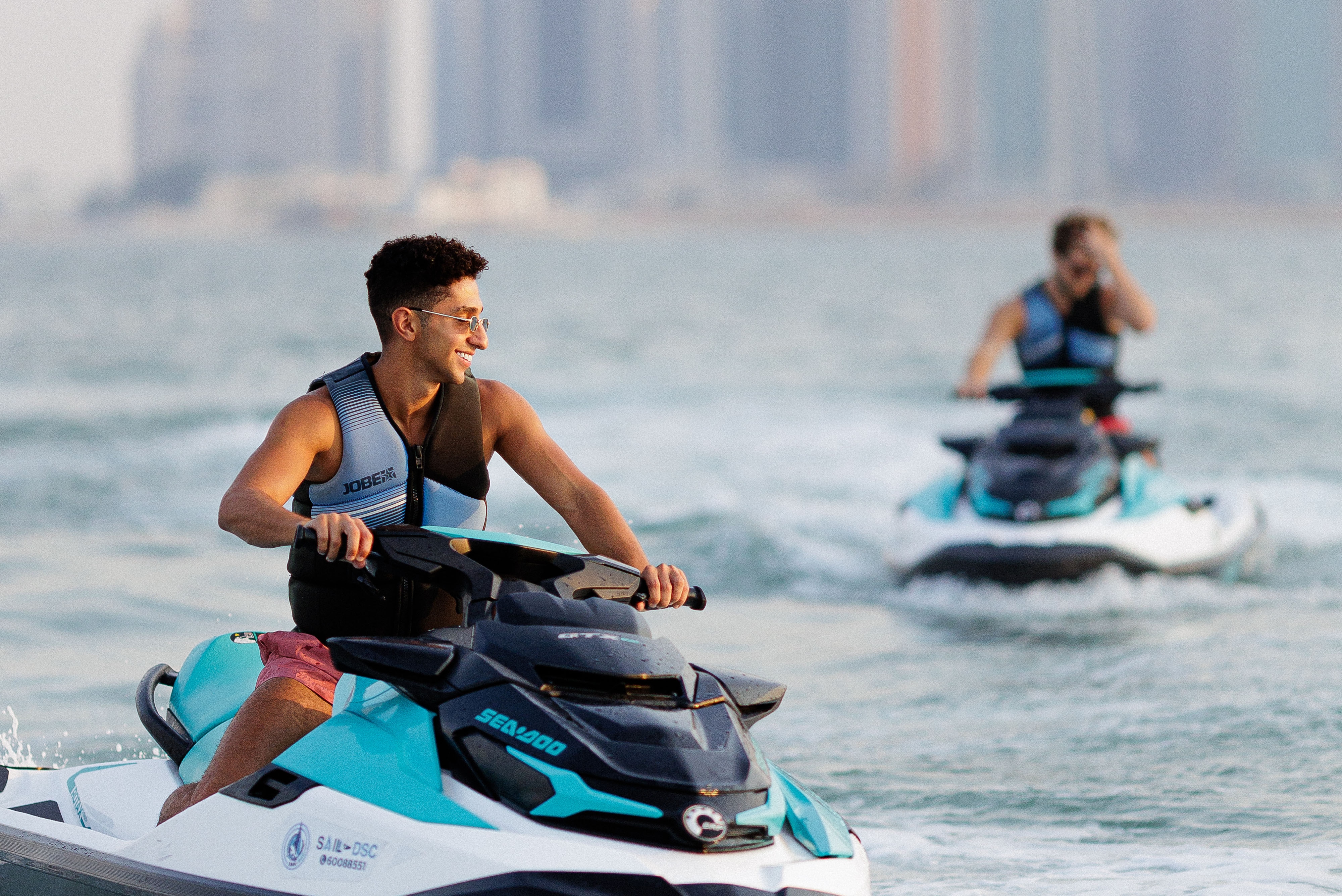 Two men on water jetskiis