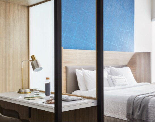 Guest room with a double bed, work desk and sofa