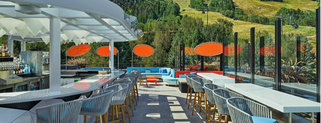 Outdoor bar and seating areas with view of mountain range