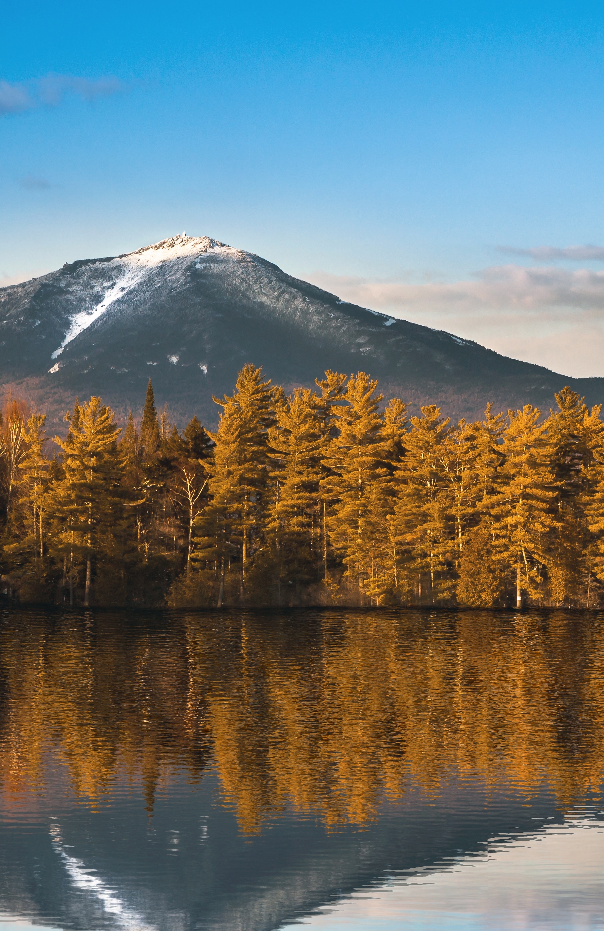 The towering Whiteface Mountains are reflected in the glassy waters of Lake Placid in the Adirondack Mountains in New York