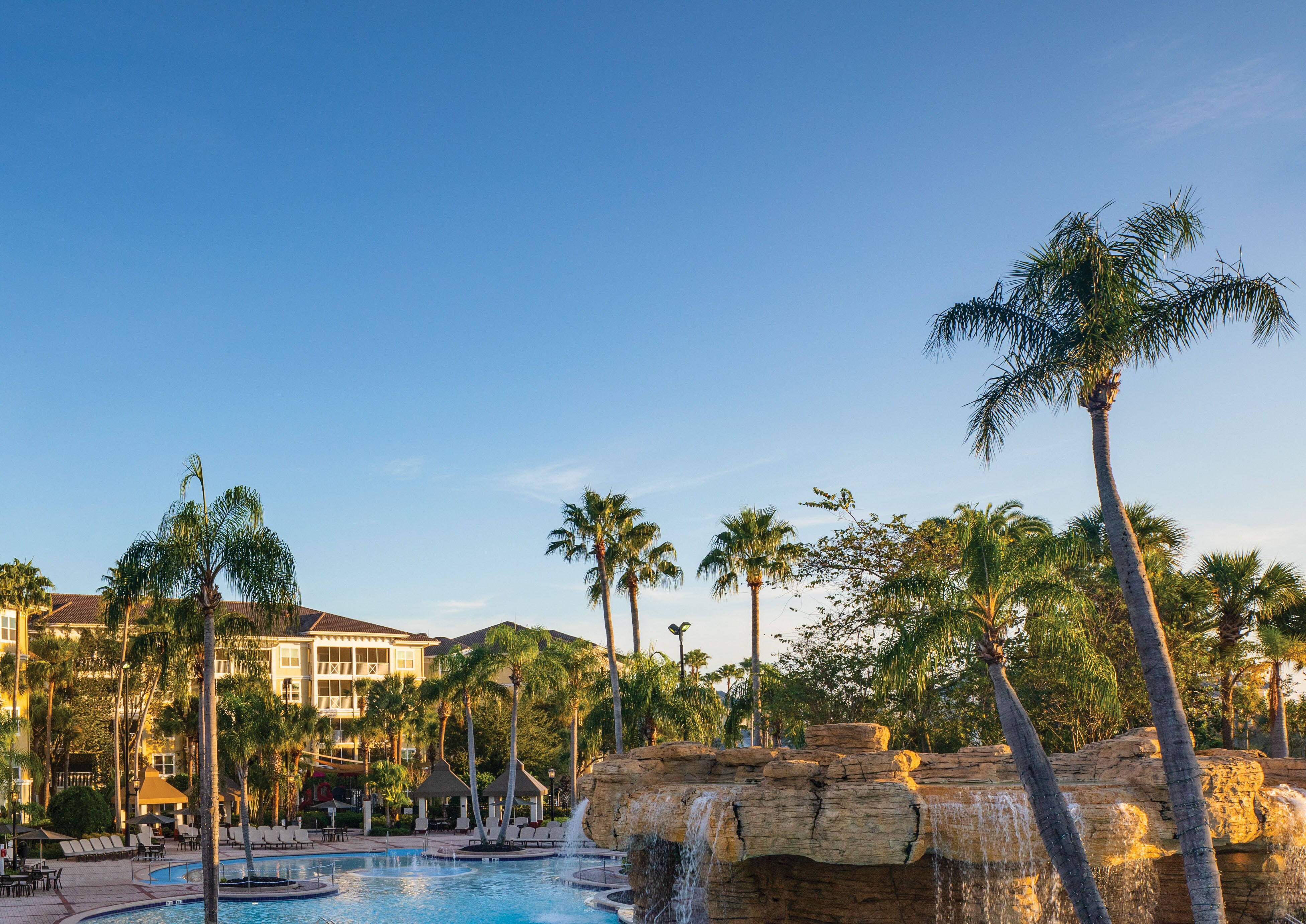 hotel with a pool and palm trees