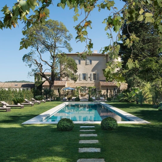 Tall villa overlooking pool set against expansive vineyards