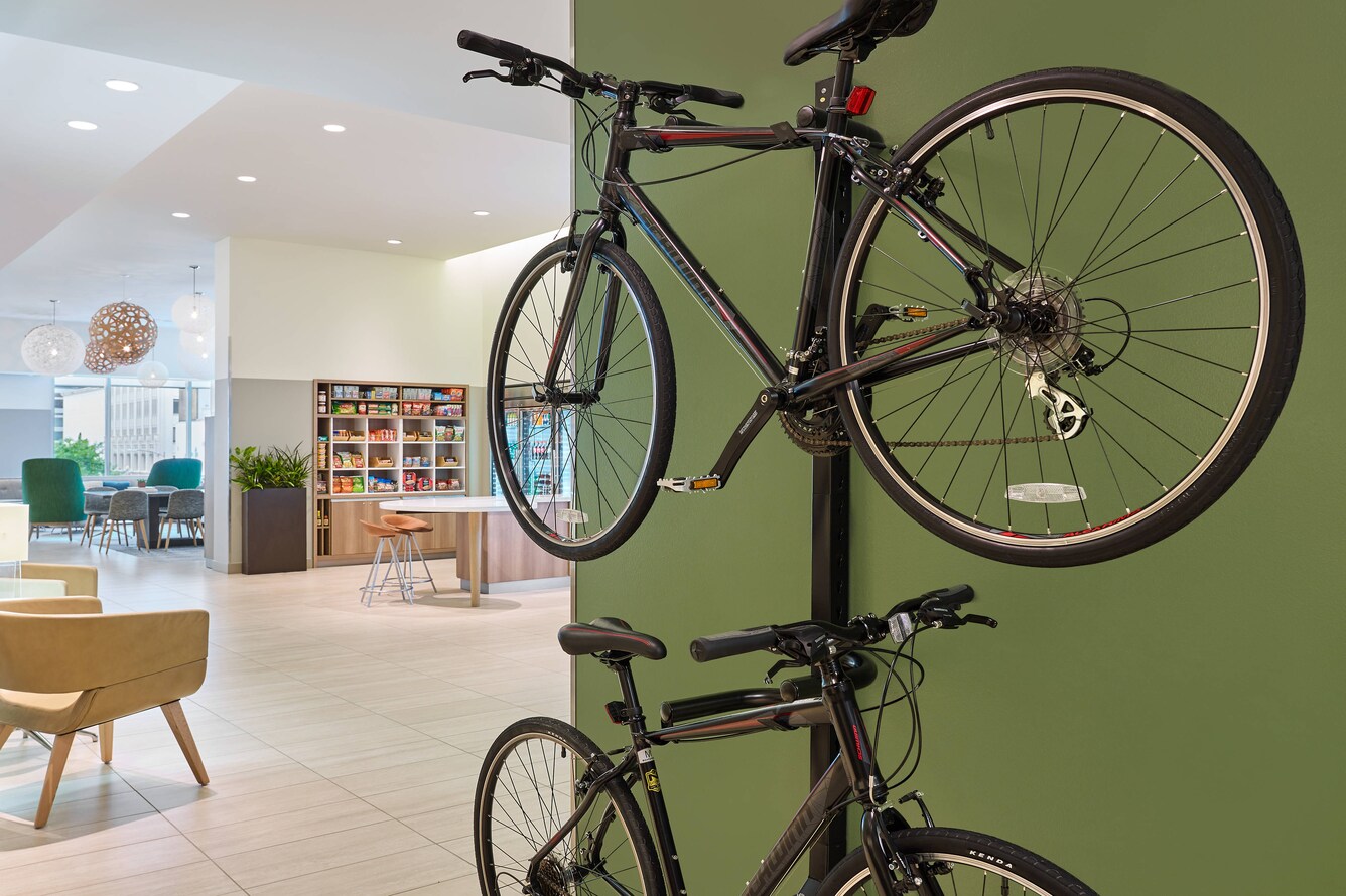 Two mountain bikes hanging on a wall mounted storage rack