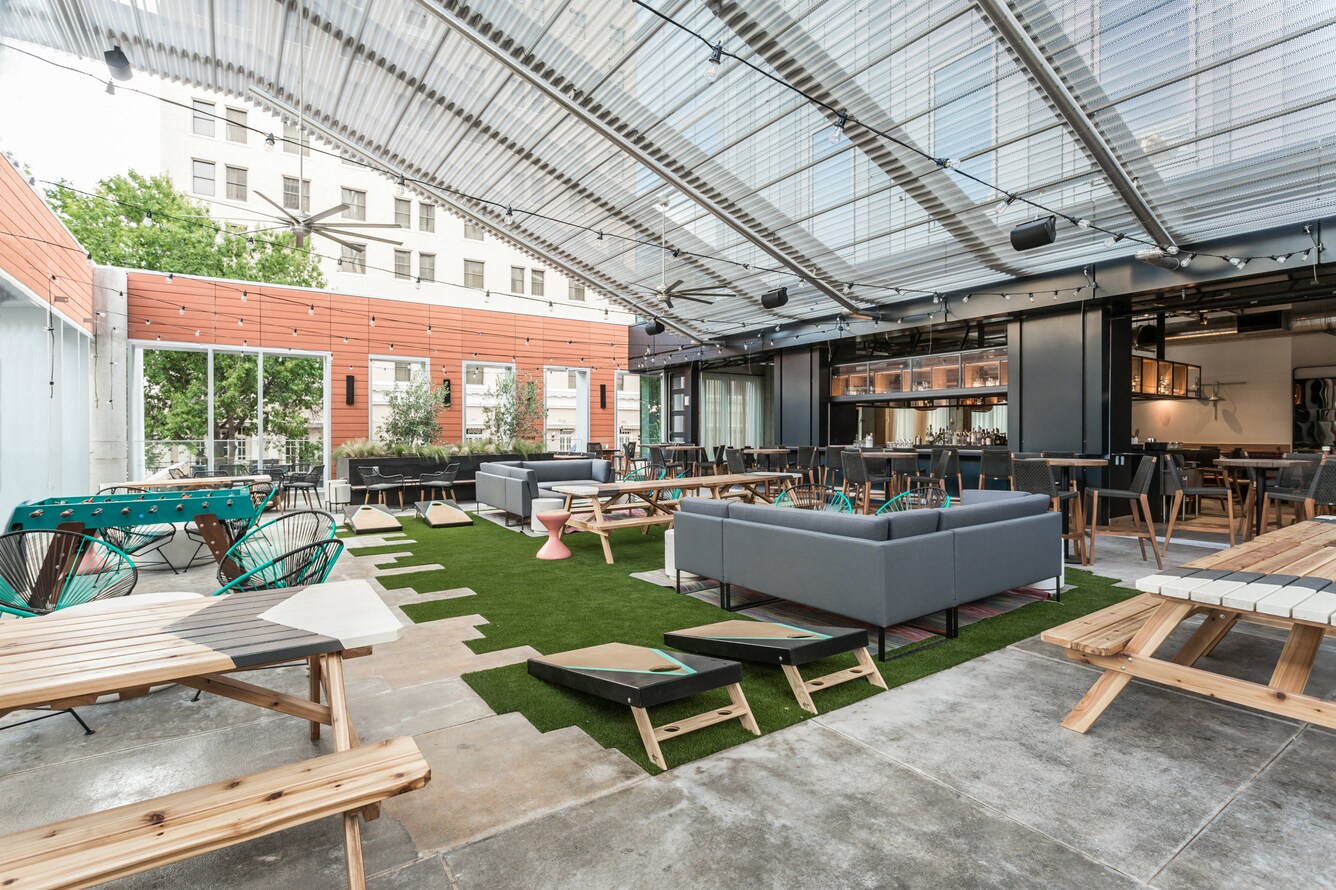outdoor covered area with backyard style seating and yard games