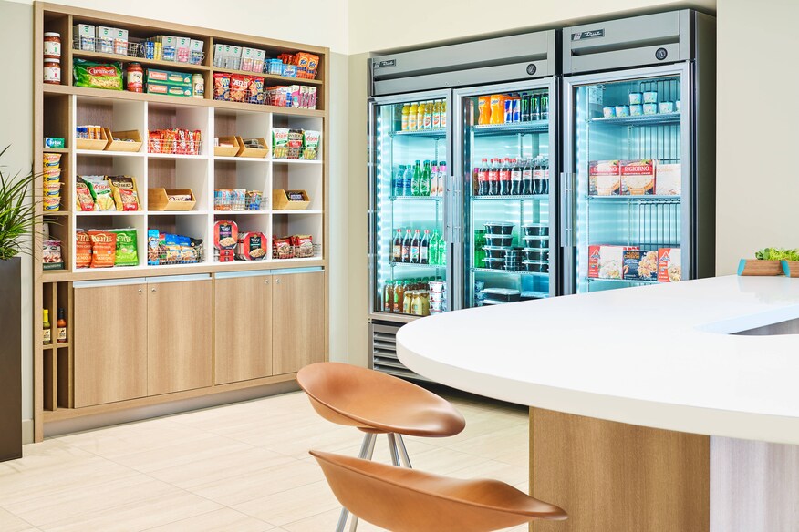 pantry with refrigerator, snacks, and nearby table