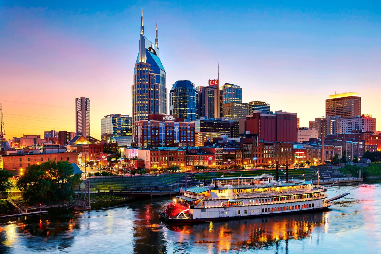 Riverboat on river with Nashville skyline in the background.