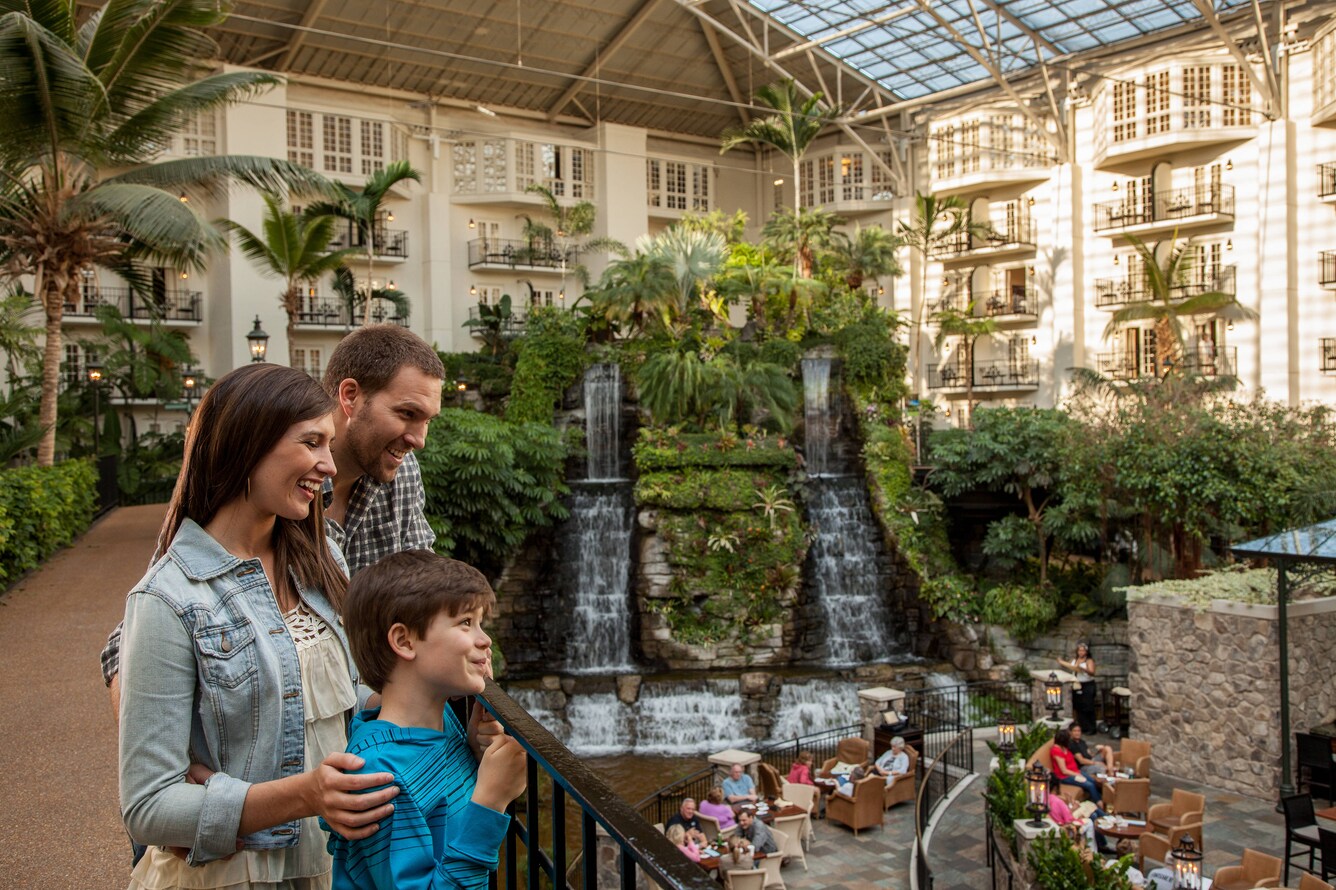 Family overlooking water feature in atrium.