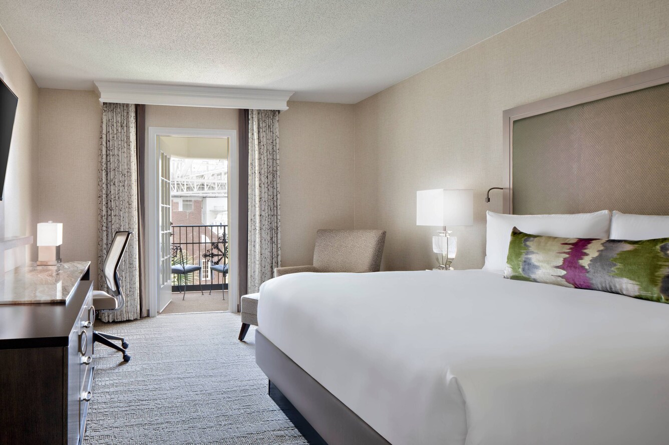 Guest room with bed and nearby balcony.