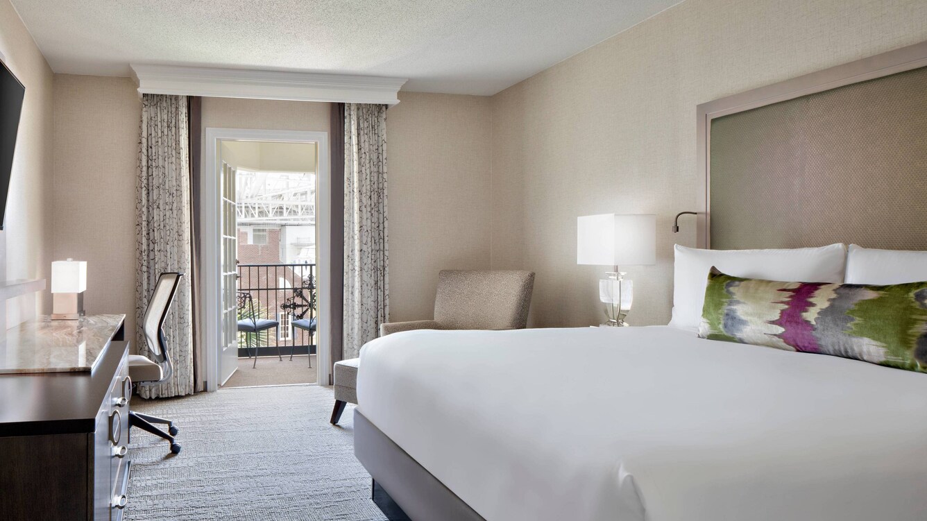 Guest room with bed and nearby balcony