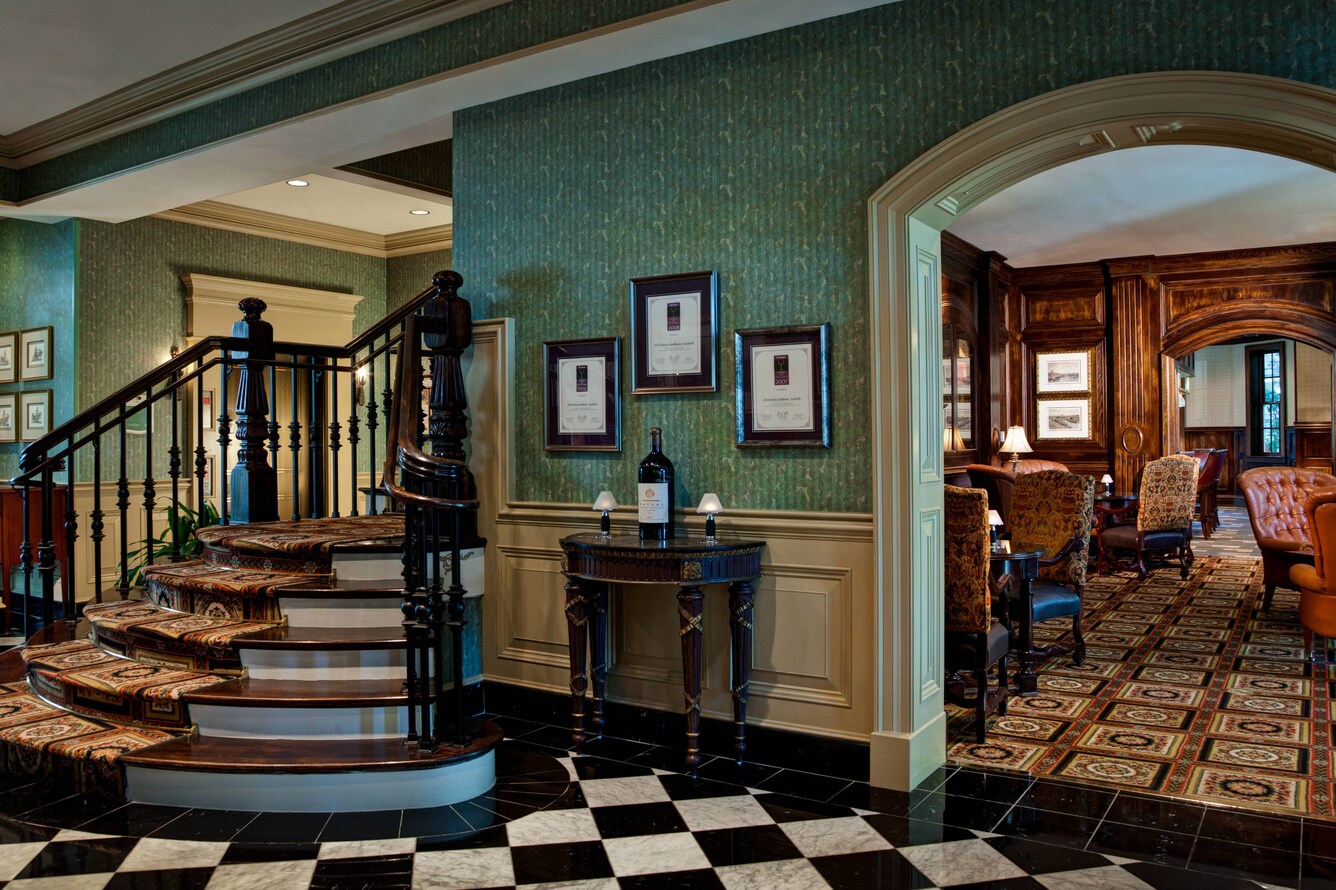 View inside Old Hickory steakhouse with staircase and sitting area.