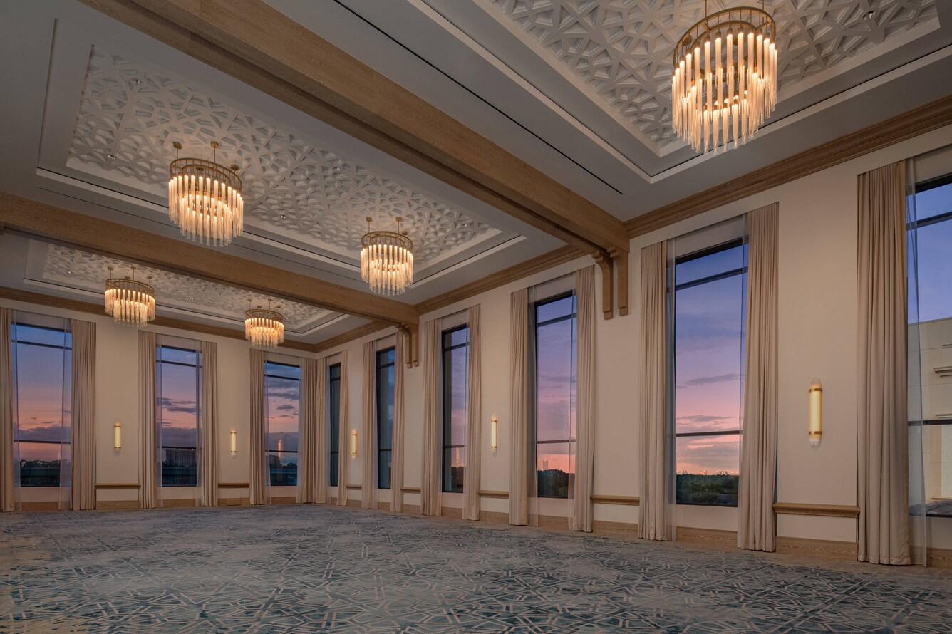 View of sunset from tall ballroom windows.