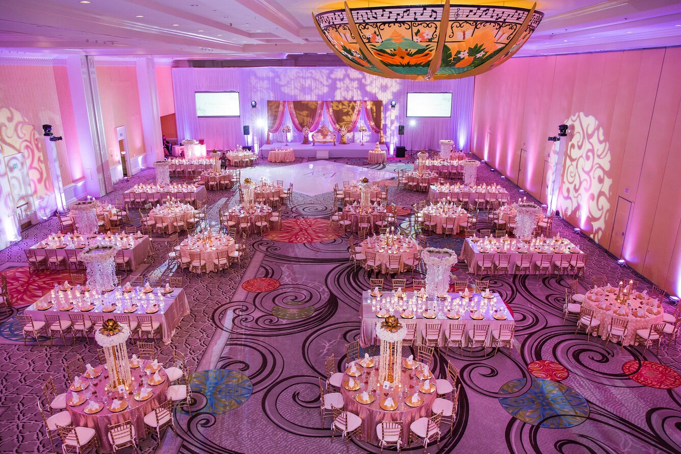 Sun ballroom reception setup with pink lighting