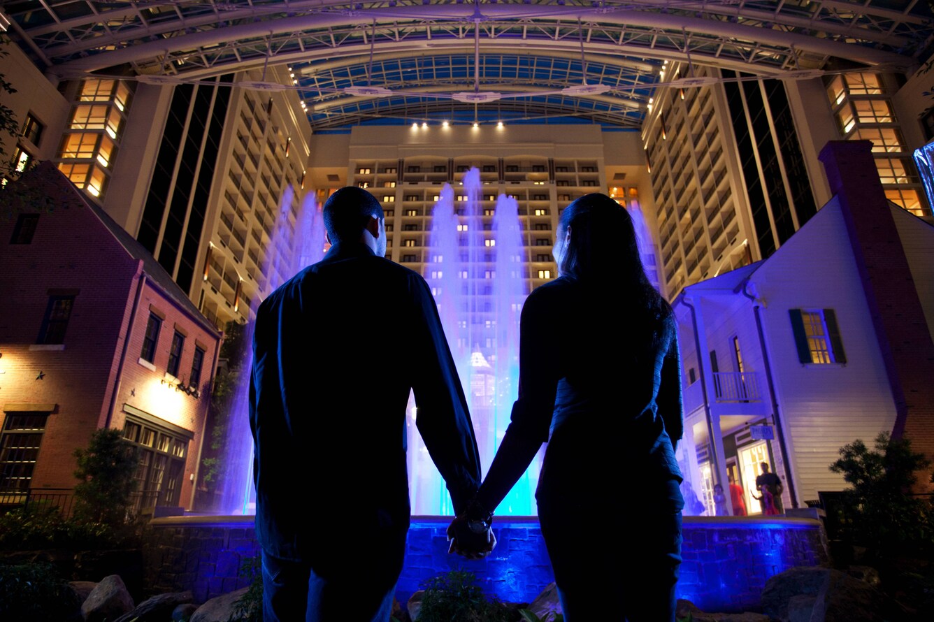 Silhouette of a couple in front of a fountain in the atrium.