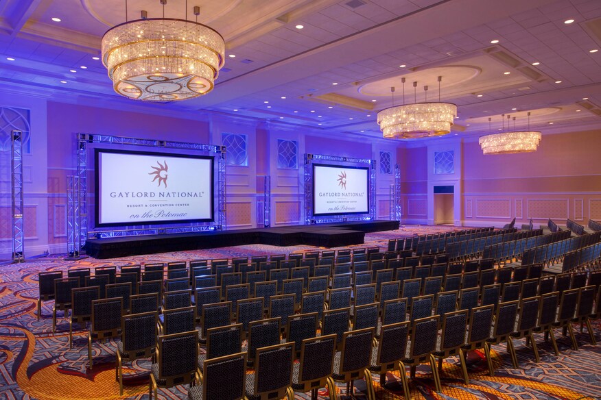 Room with chairs laid out and screens at the front