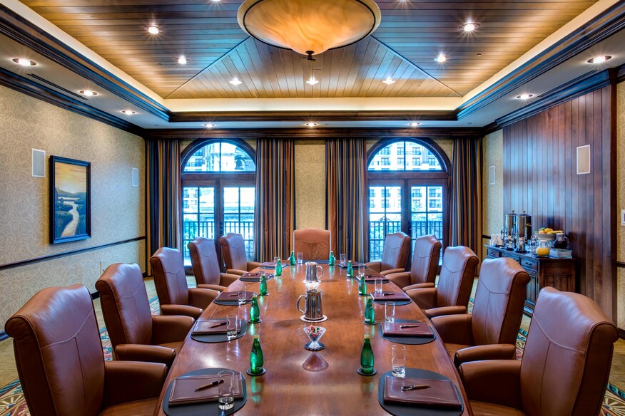 Bluebonnet boardroom with large conference table, leather chairs and arched windows