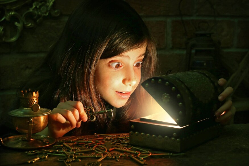 Child opening glowing treasure chest
