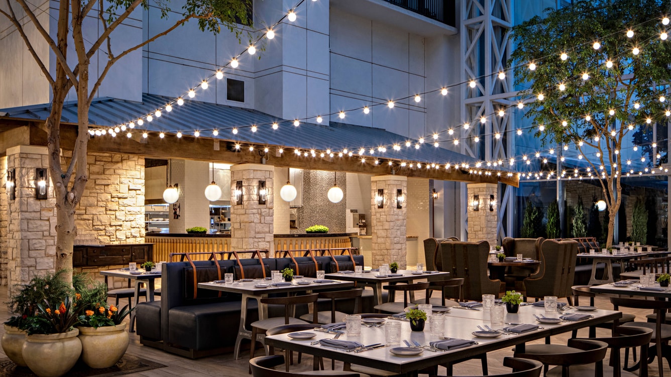 Patio view of zeppole restaurant with tables set and string lights