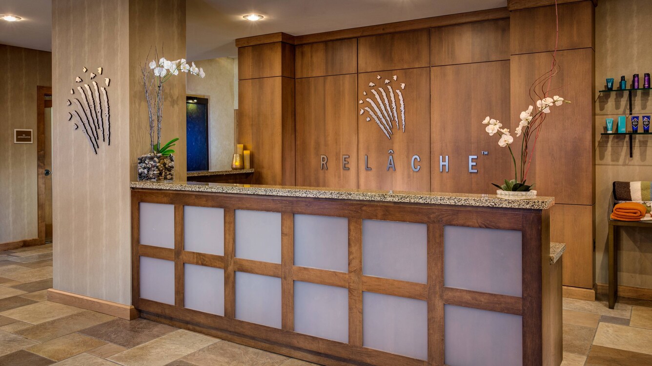 Relache spa receptionist counter with orchids and wood details