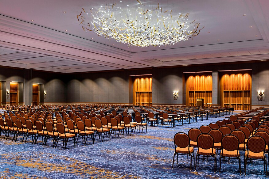 The tate ballroom setup theater style with blue rug and chandelier