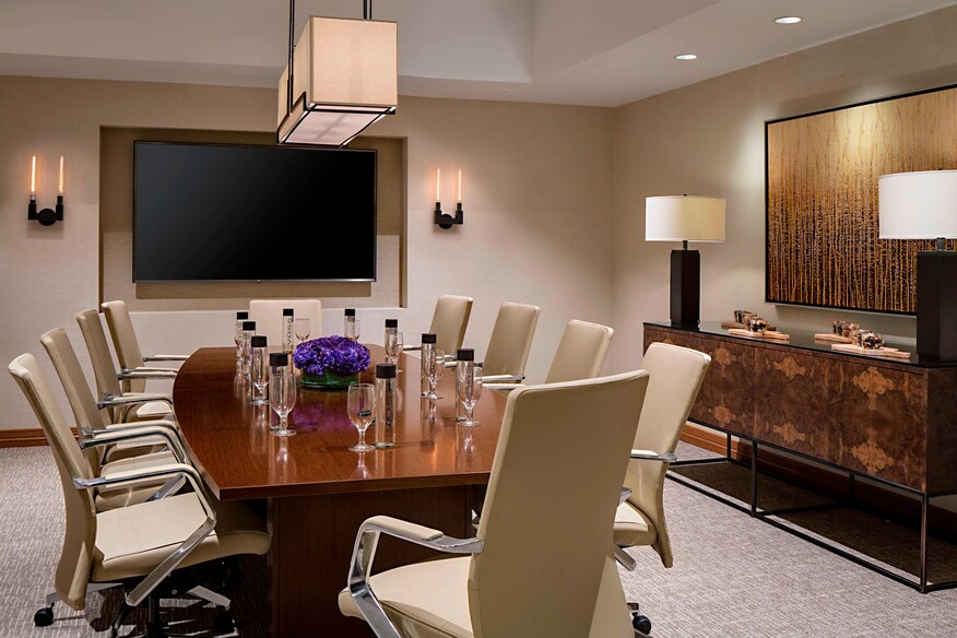 Vineyard boardroom with purple centerpiece and water glasses setup