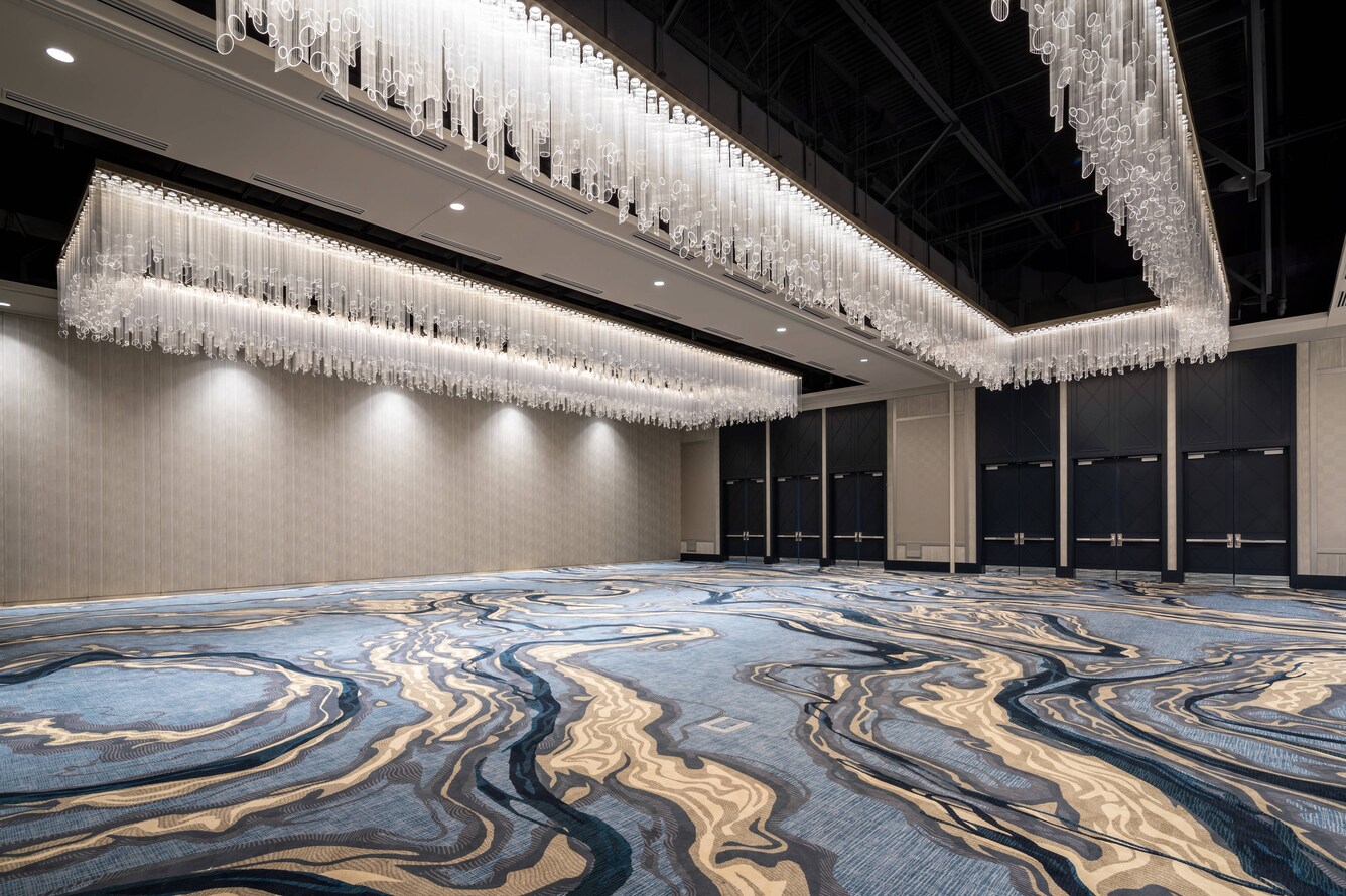 Empty floor and unique tubular glass ceiling lights of the Juiper Ballroom.