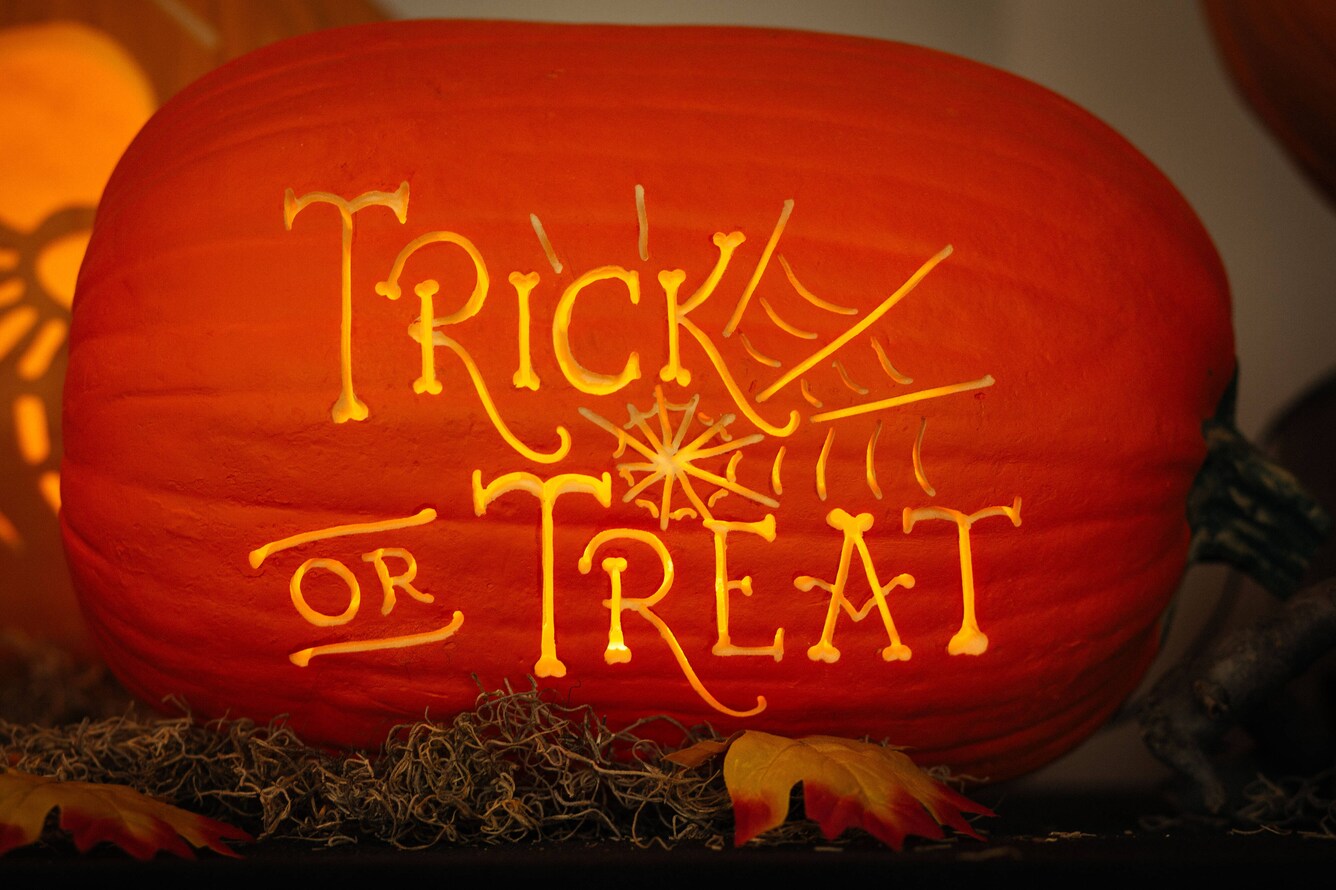 pumpkin with Trick or Treat carved in it