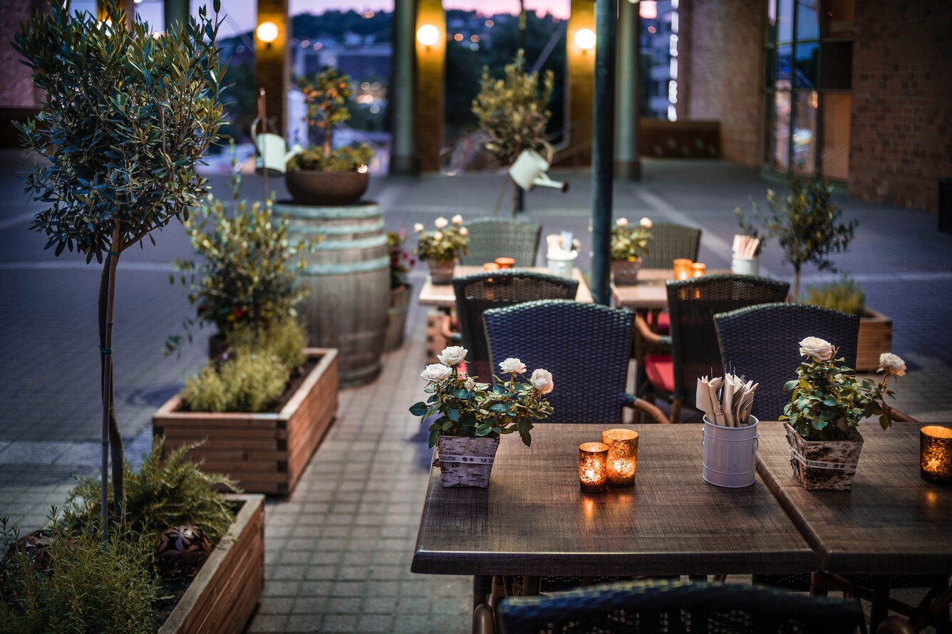 Outdoor terrace with dining tables in the day time