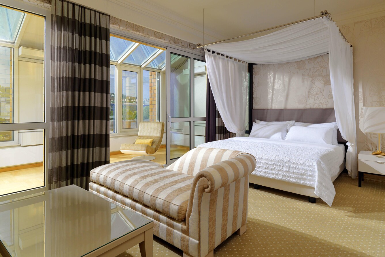 Suite with bed, and sofa a sitting room nearby