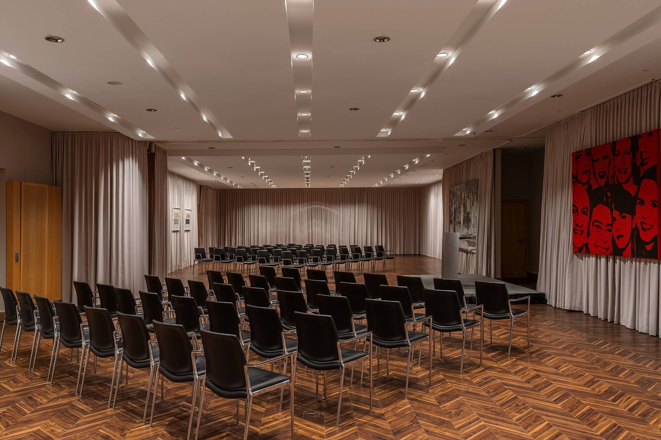 meeting room with rows of black chairs